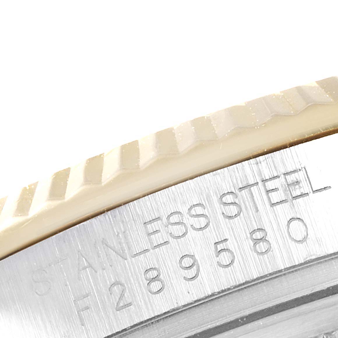 This image shows a close-up of the fluted bezel and engraved text on the case side of a Rolex Datejust 116233 Men's Steel and Gold (two tone) Champagne Dial 116233 Men's Steel and Gold (two tone) Champagne Dial watch.