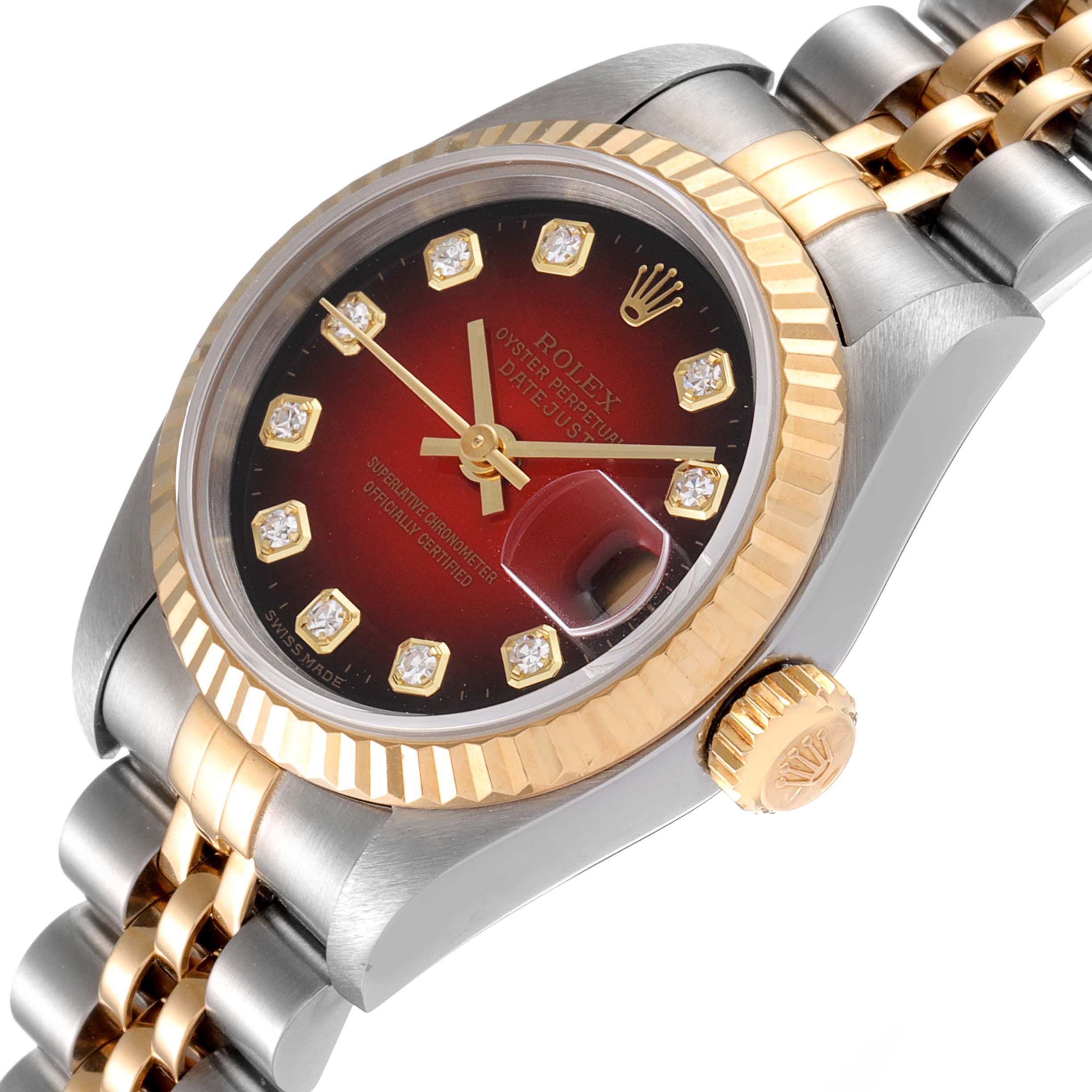 The image shows a close-up, angled view of a Rolex Datejust 79173 Women
s Steel and Gold (two tone) Red Dial 79173 Women
s Steel and Gold (two tone) Red Dial watch, focusing on its face, bezel, and part of the band.