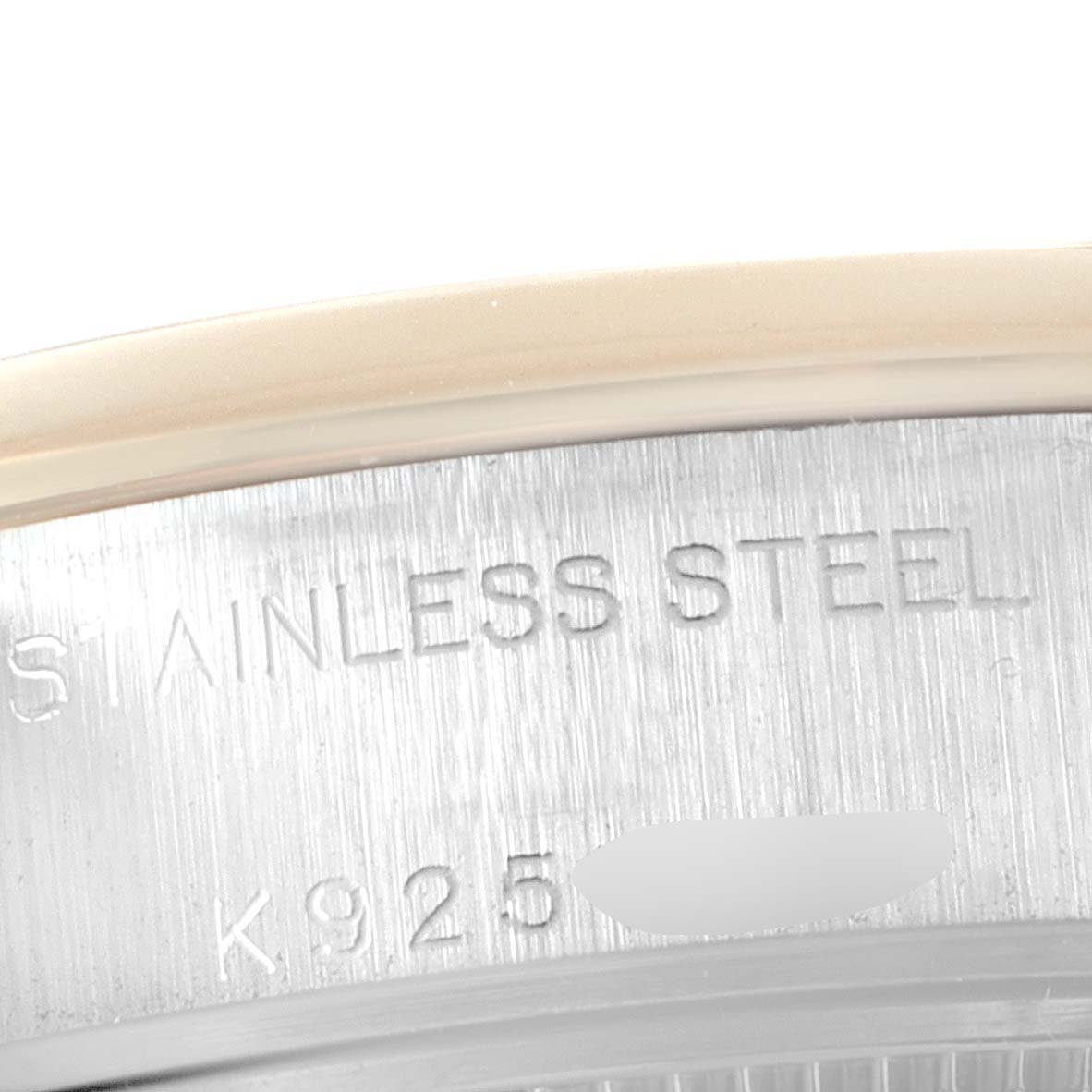This close-up angle shows the stainless steel engraving on the case of a Rolex Datejust 79163 Women's Steel and Gold (two tone) White Dial 79163 Women's Steel and Gold (two tone) White Dial watch.