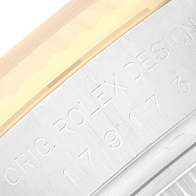 The image shows a close-up of the engraved case edge and bezel of a Rolex Datejust 179173 Women's Steel and Gold (two tone) White Dial 179173 Women's Steel and Gold (two tone) White Dial watch.