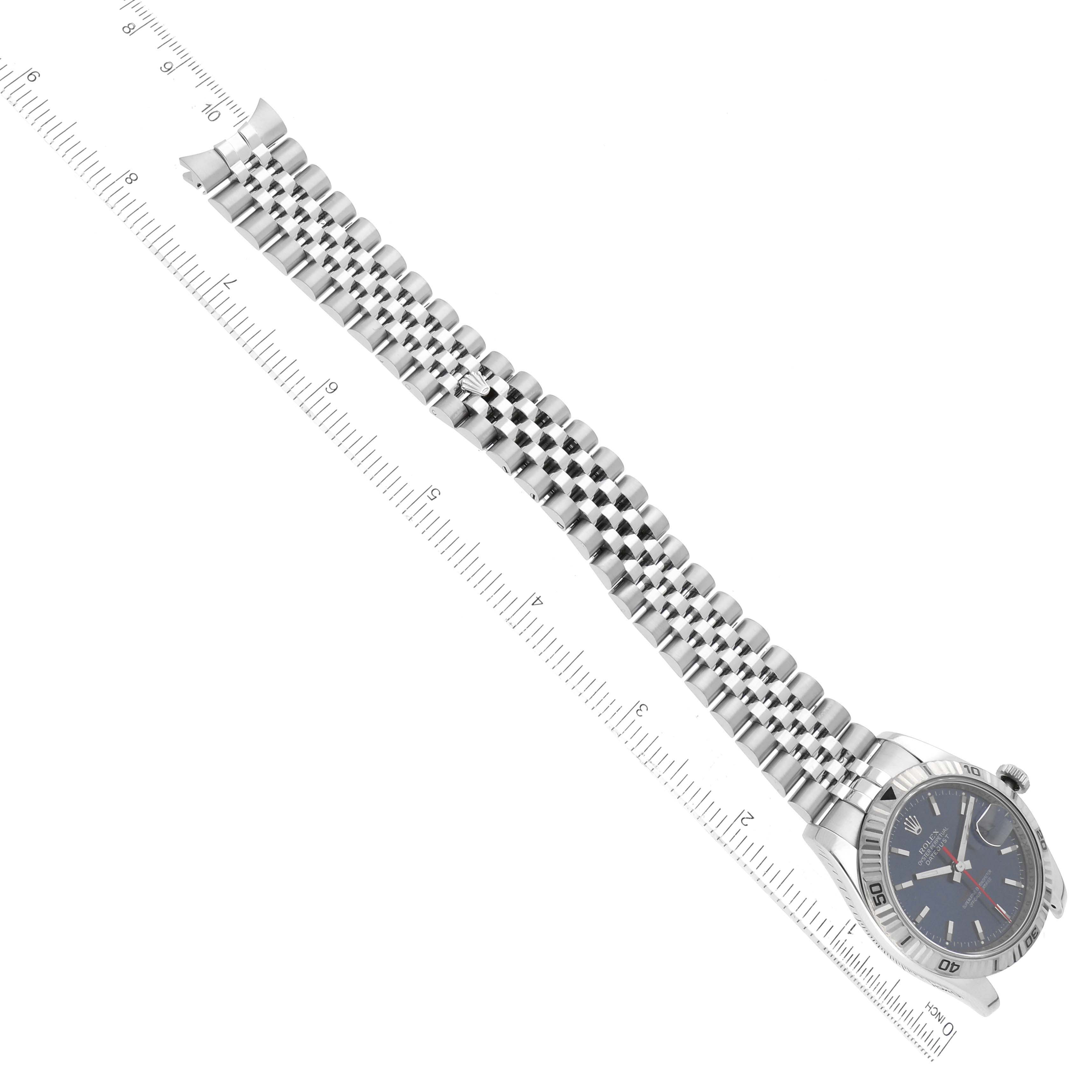 This image shows the Rolex Datejust 116264 Men's Stainless Steel Blue Dial 116264 Men's Stainless Steel Blue Dial watch laid flat with its bracelet extended alongside a ruler for measurement.