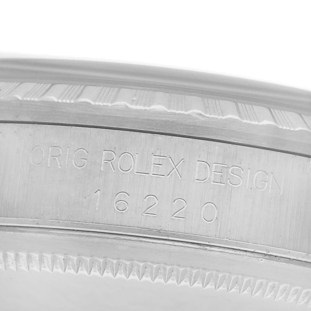 The image shows the side engraving of a Rolex Datejust 16220 Men's Stainless Steel White Dial 16220 Men's Stainless Steel White Dial, displaying the model number "16220" and the text "ORIG ROLEX DESIGN".
