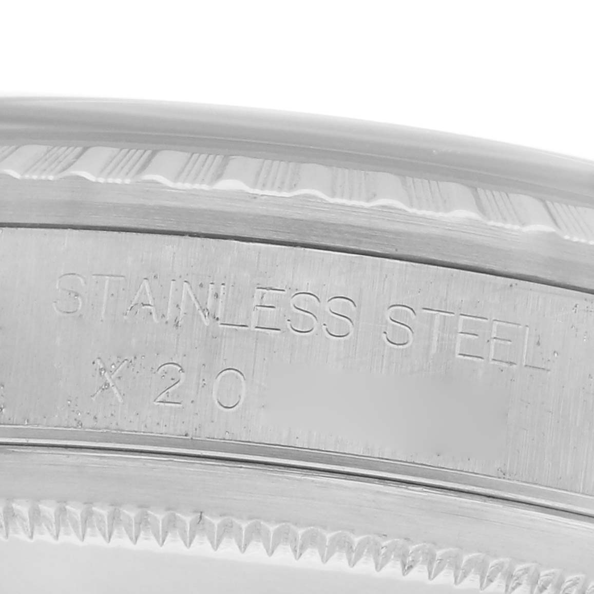 The image shows a close-up of the side of a Rolex Datejust 16220 Men's Stainless Steel White Dial 16220 Men's Stainless Steel White Dial watch, focusing on the stainless steel engraving.