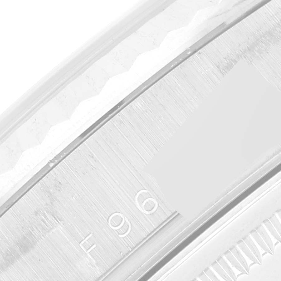 This close-up image shows the edge of the bezel and part of the case with the serial number of a Rolex President 118239 Men's White Gold Silver Dial 118239 Men's White Gold Silver Dial model watch.
