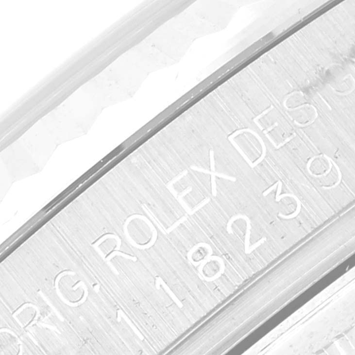 This image shows a close-up angle of the inner bezel of a Rolex President 118239 Men's White Gold Silver Dial 118239 Men's White Gold Silver Dial model watch, displaying part of the serial number and brand.