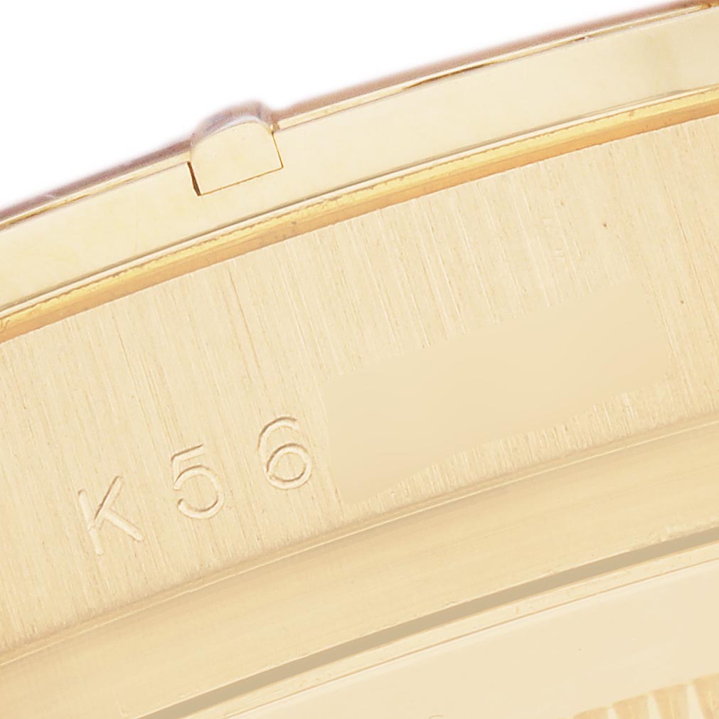 The image shows a close-up of the gold-colored side engraving on a Rolex Daytona 116568BR Men's Yellow Gold Mother of Pearl Dial 116568BR Men's Yellow Gold Mother of Pearl Dial watch.