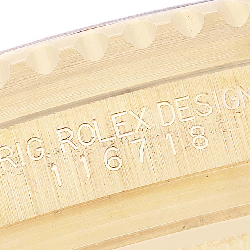 This image shows an angled, close-up view of the engraved side of a Rolex GMT-Master 116718 Men's Yellow Gold Green Dial 116718 Men's Yellow Gold Green Dial watch case with the model number 116718 visible.