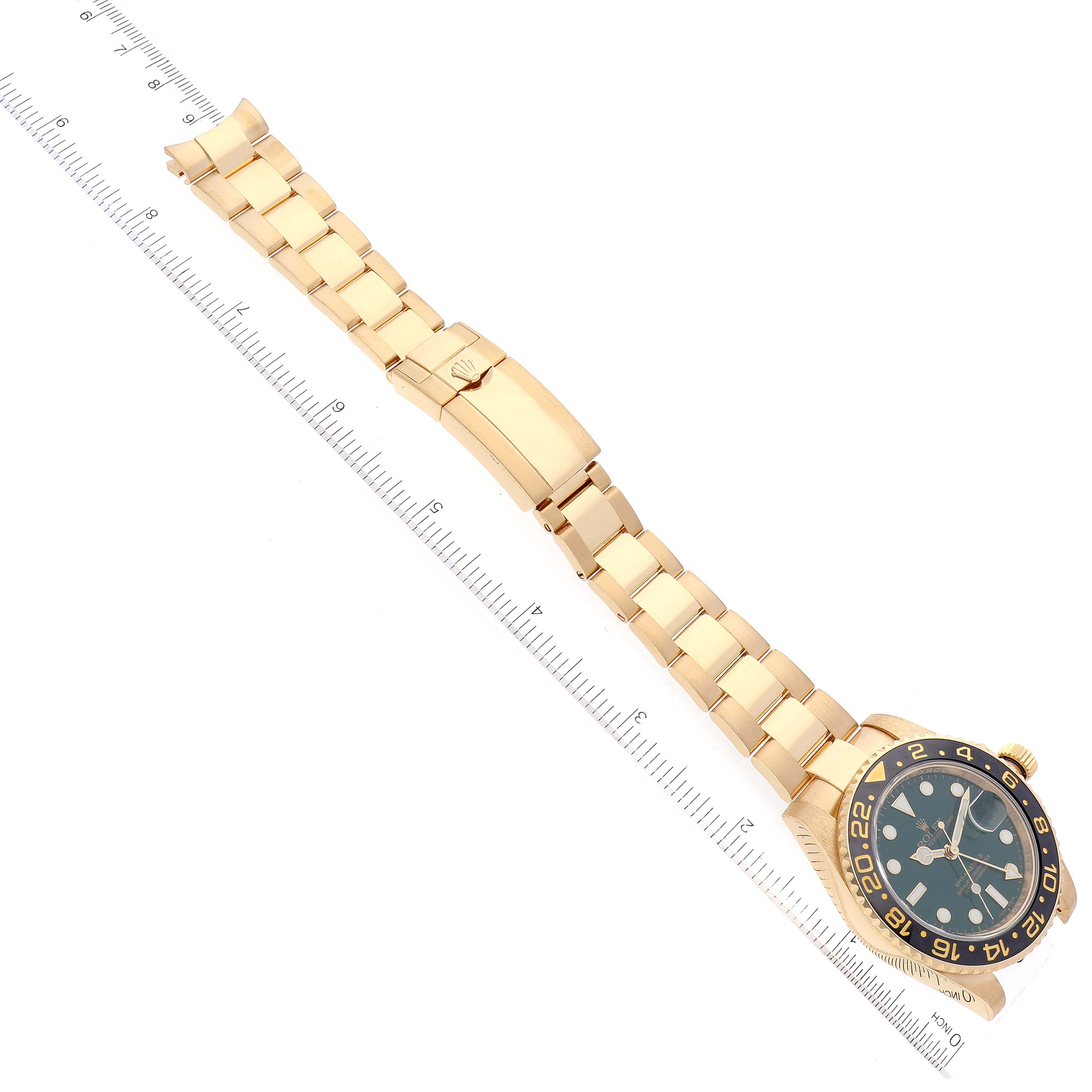 The image shows the Rolex GMT-Master 116718 Men's Yellow Gold Green Dial 116718 Men's Yellow Gold Green Dial watch laid flat with a visible face, bezel, and entire bracelet, along with a measuring ruler.