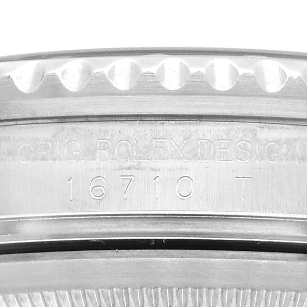 This image shows a close-up of the side view of a Rolex GMT-Master 16710 Men
s Stainless Steel Black Dial 16710 Men
s Stainless Steel Black Dial watch, focusing on the case with an engraved model number "16710 T."
