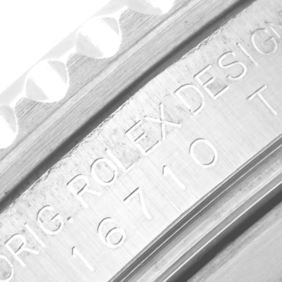 The image shows a close-up of the side engravings on the bezel and case of a Rolex GMT-Master 16710 Men's Stainless Steel Black Dial 16710 Men's Stainless Steel Black Dial model 16710.