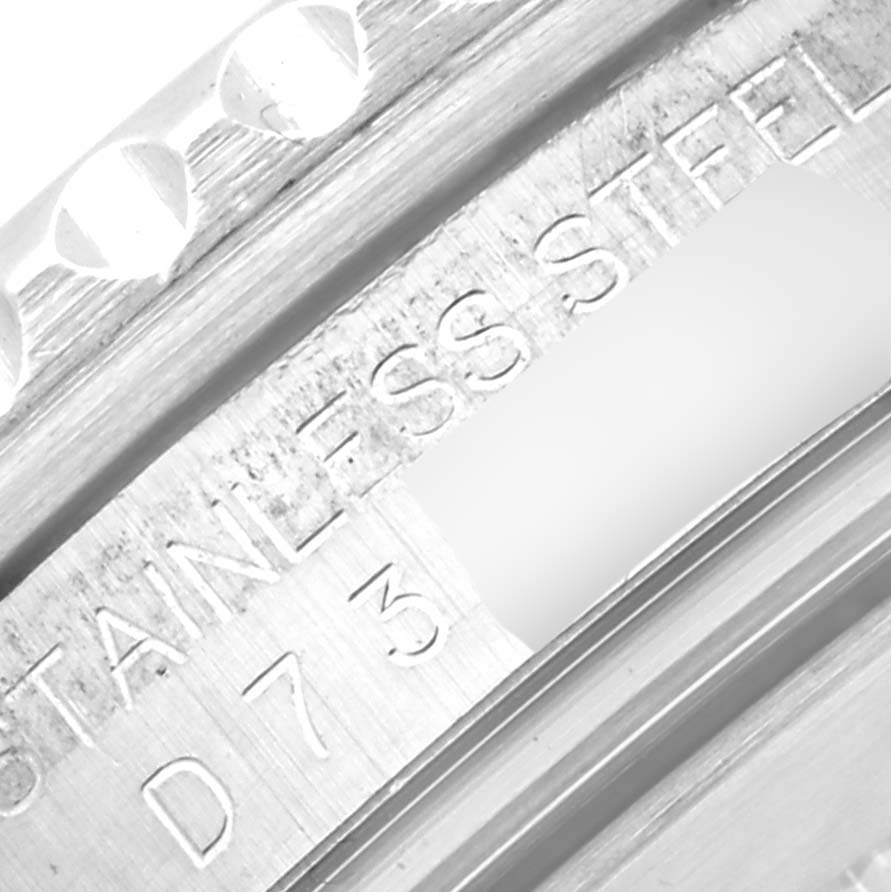 This close-up image shows the engraved serial number and "STAINLESS STEEL" on the bezel of a Rolex GMT-Master 16710 Men's Stainless Steel Black Dial 16710 Men's Stainless Steel Black Dial watch.