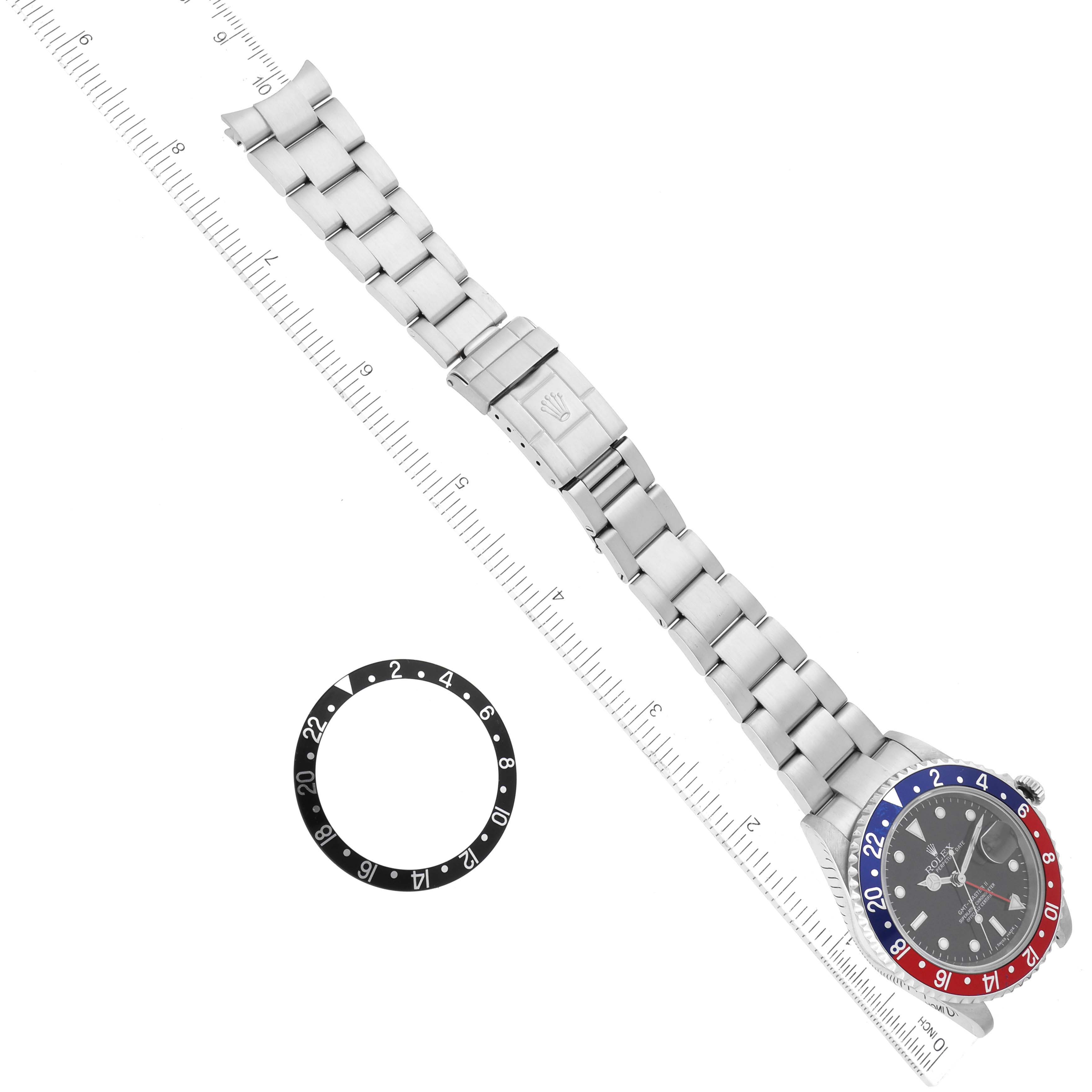 The image shows a top-down view of a Rolex GMT-Master 16710 Men's Stainless Steel Black Dial 16710 Men's Stainless Steel Black Dial watch with a metal bracelet, along with an additional bezel ring.