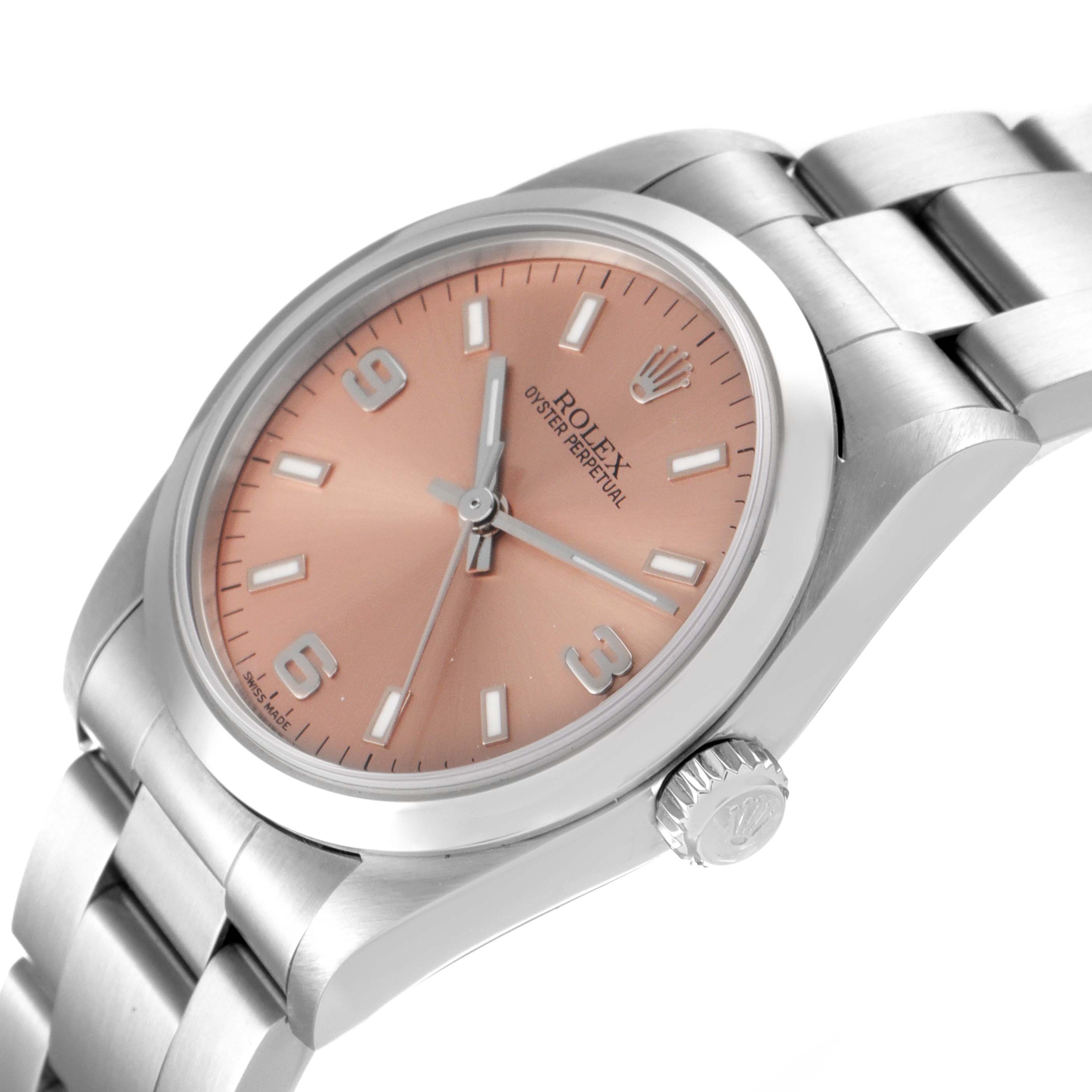 This image shows a side and angled view of a Mid-Size Rolex Oyster Perpetual watch featuring a pink dial and stainless steel bracelet.