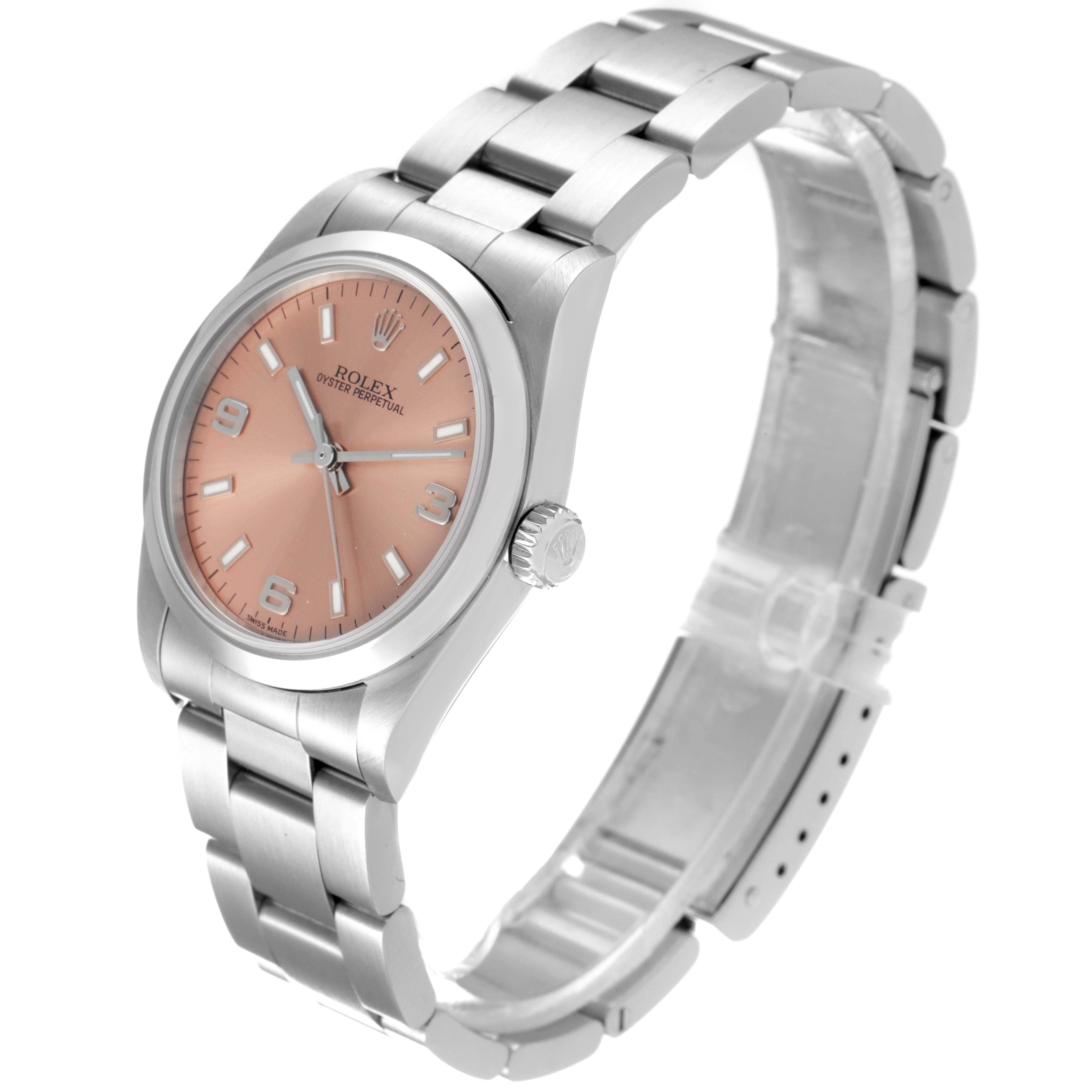 The image shows a Rolex Mid-Size 77080 Women
s Stainless Steel Pink Dial 77080 Women
s Stainless Steel Pink Dial model watch at a slight angle, displaying its face, bezel, crown, and stainless steel bracelet.