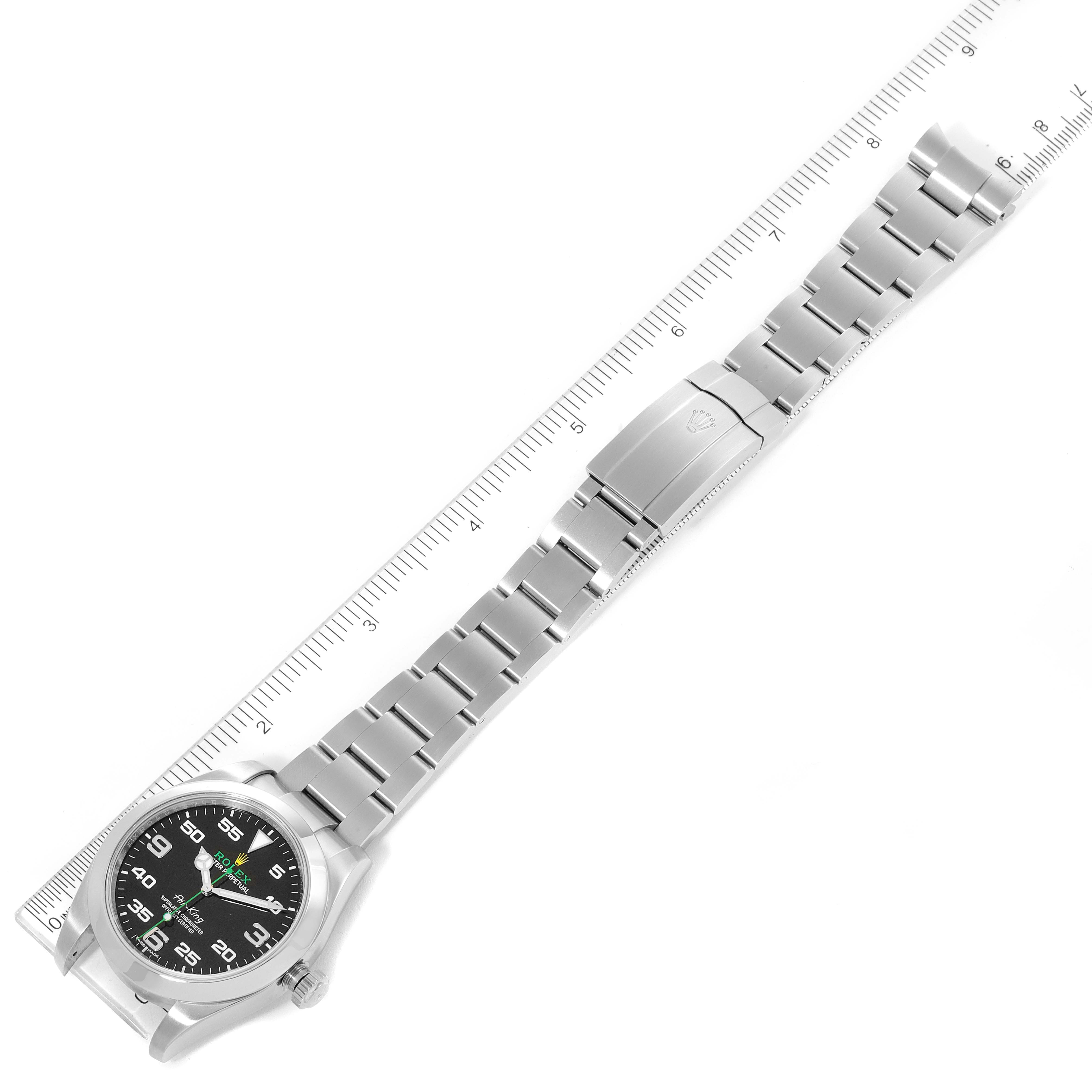 The image shows a top-down view of a Rolex Air-King 116900 Men's Stainless Steel Black Dial 116900 Men's Stainless Steel Black Dial watch with its bracelet fully extended along a ruler for scale.