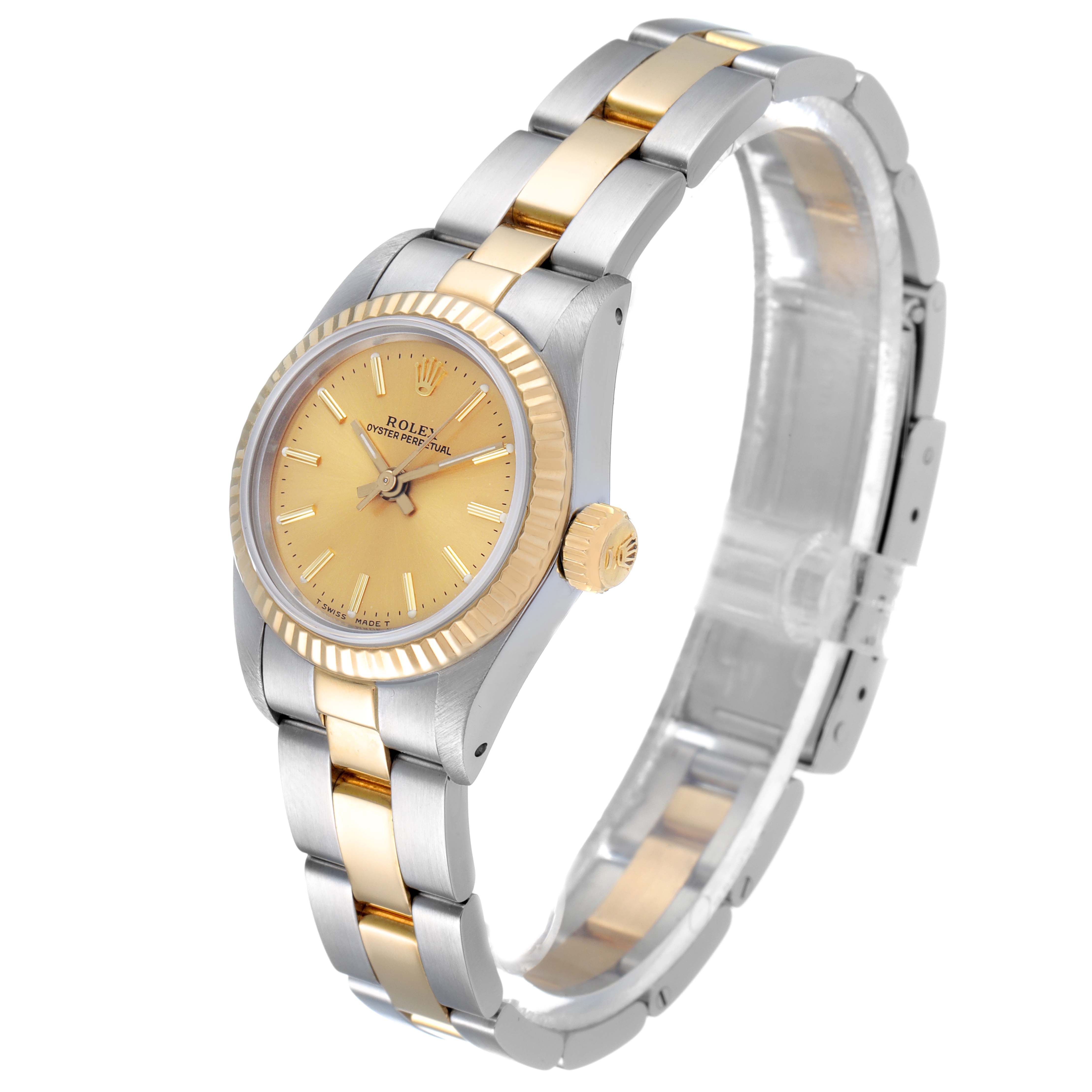The Rolex Oyster Perpetual 67193 Women
s Steel and Gold (two tone) Champagne Dial 67193 Women
s Steel and Gold (two tone) Champagne Dial watch is shown from a slight side angle, revealing its gold and silver bracelet and face.