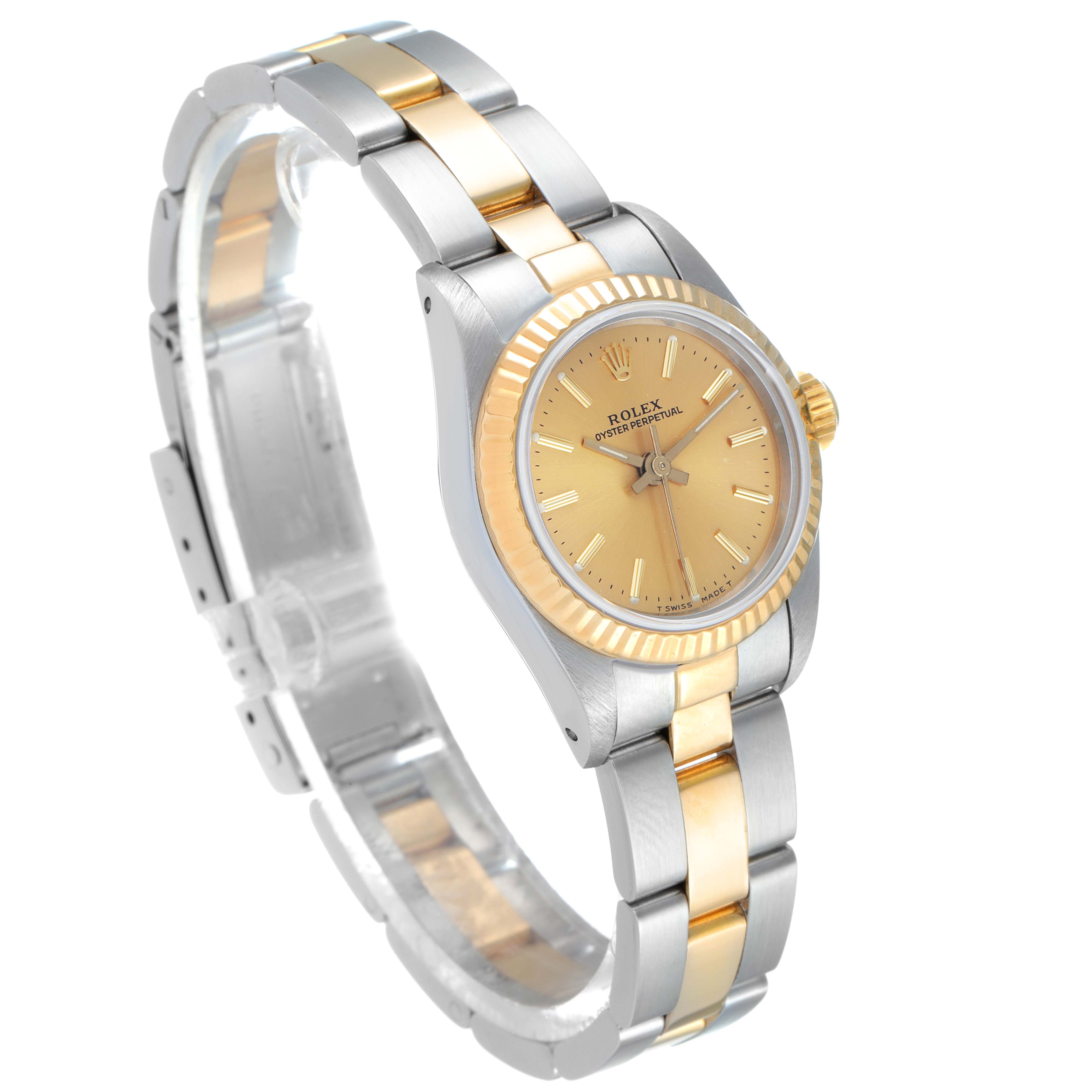 The Rolex Oyster Perpetual 67193 Women
s Steel and Gold (two tone) Champagne Dial 67193 Women
s Steel and Gold (two tone) Champagne Dial watch is shown at a slight angle, displaying the gold and silver band, bezel, and gold dial.