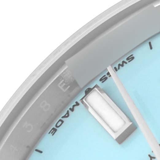 This close-up image shows a partial view of the dial, hour marker, and second hand of a Mid-Size Rolex watch.