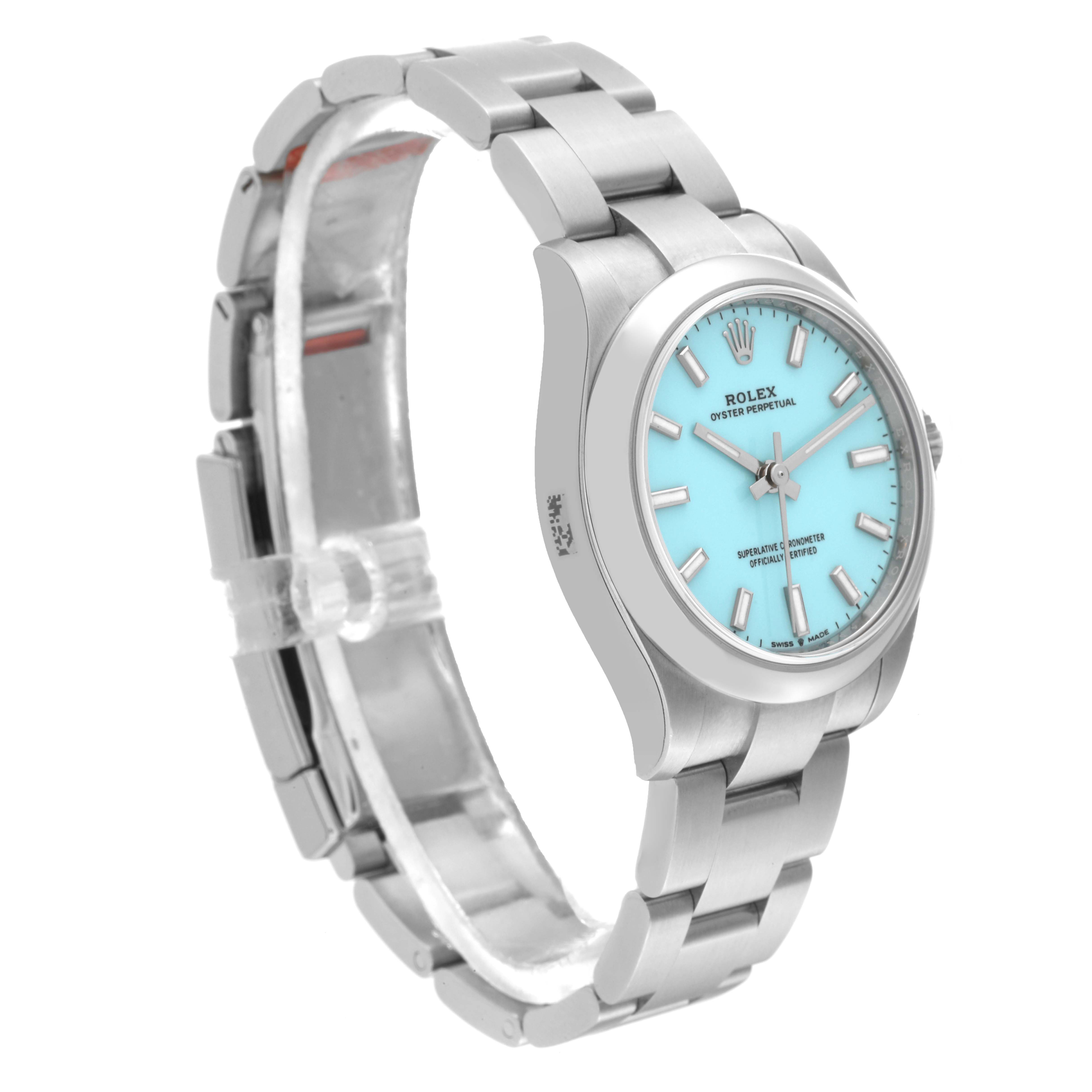 The image shows a Mid-Size Rolex Oyster Perpetual watch from an angled side view, featuring a silver bracelet and a turquoise dial.