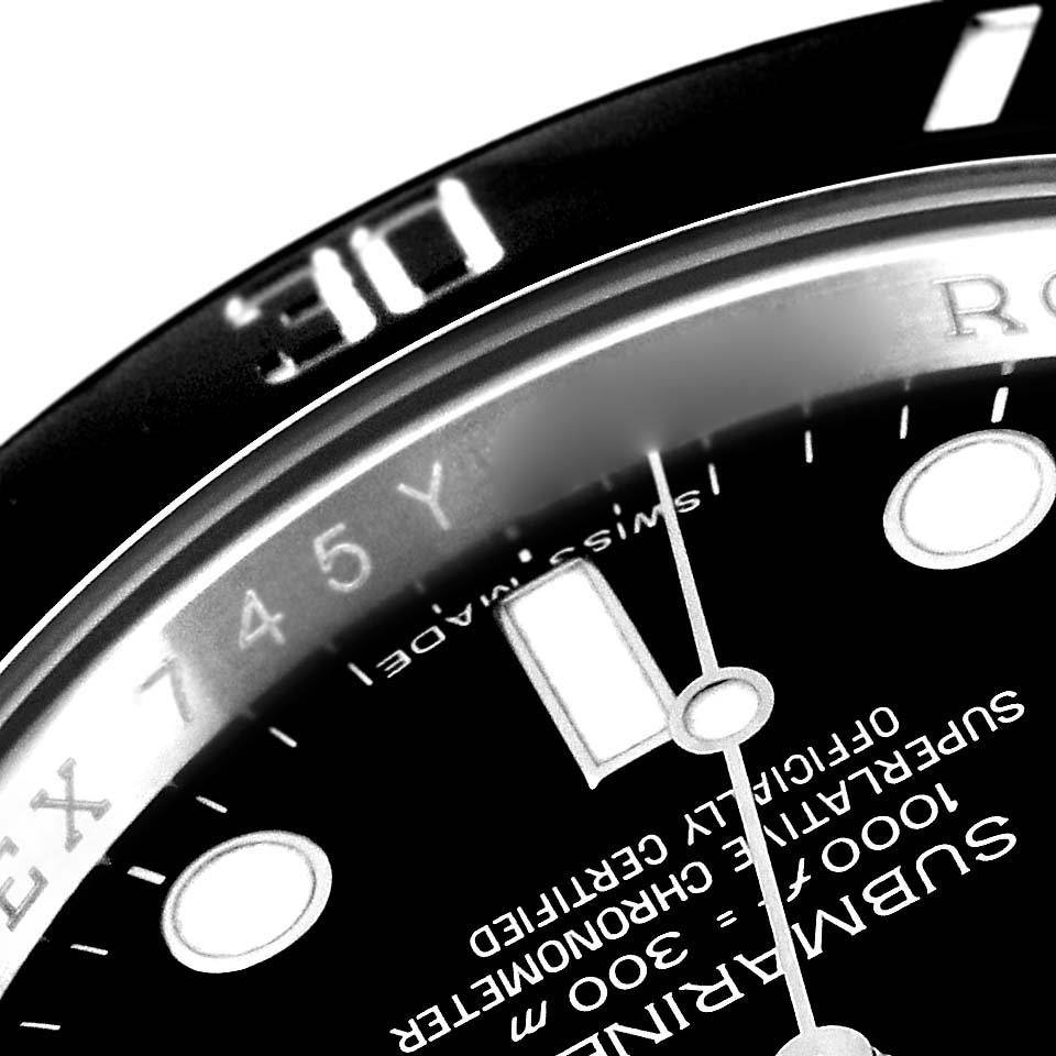 The image shows a close-up of the dial and bezel of a Rolex Submariner 114060 Men
s Stainless Steel Black Dial 114060 Men
s Stainless Steel Black Dial watch, capturing part of the minute markers and hour hand.