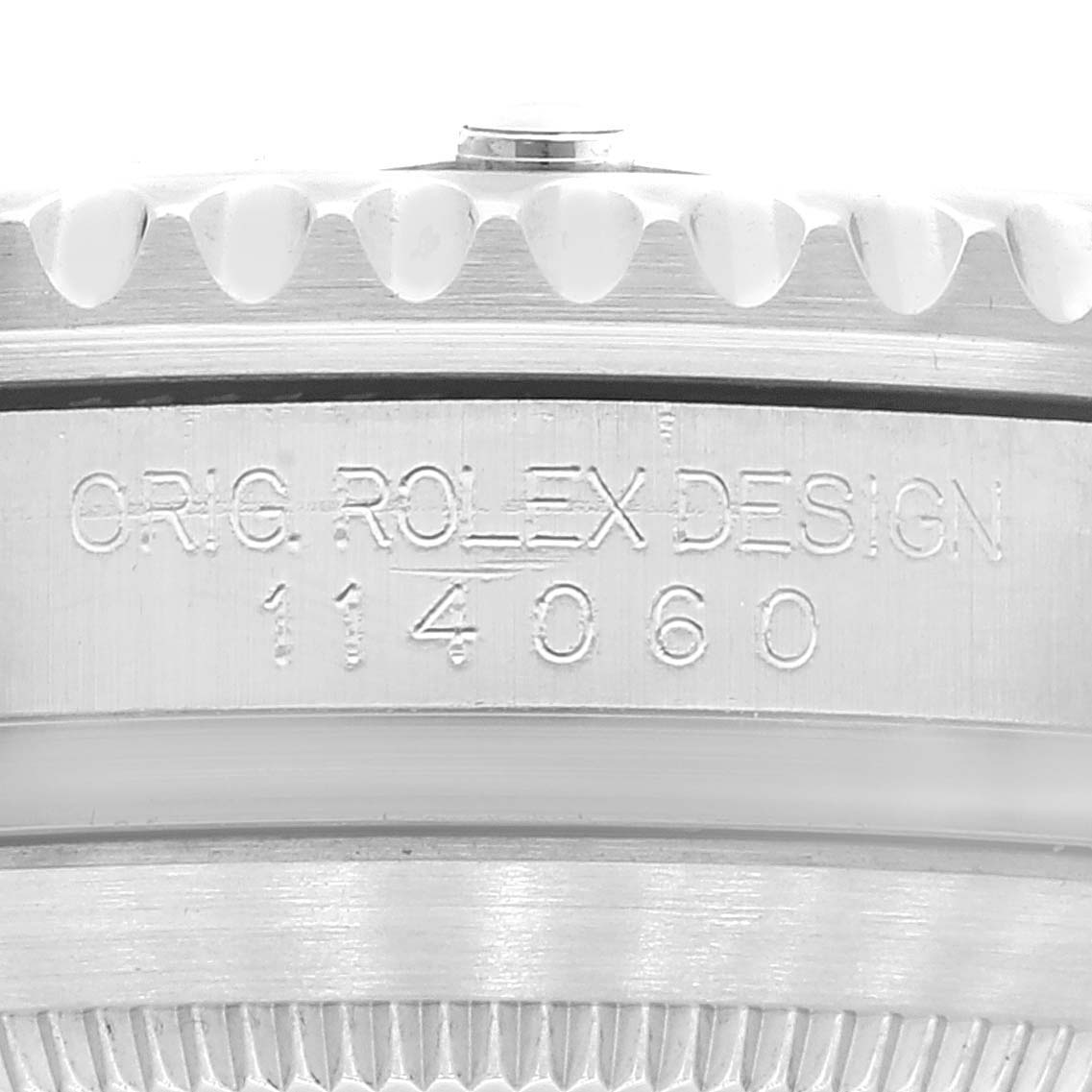 This image shows a close-up of the side of a Rolex Submariner 114060 Men
s Stainless Steel Black Dial 114060 Men
s Stainless Steel Black Dial, highlighting its model number and "ORIG ROLEX DESIGN" engraving.