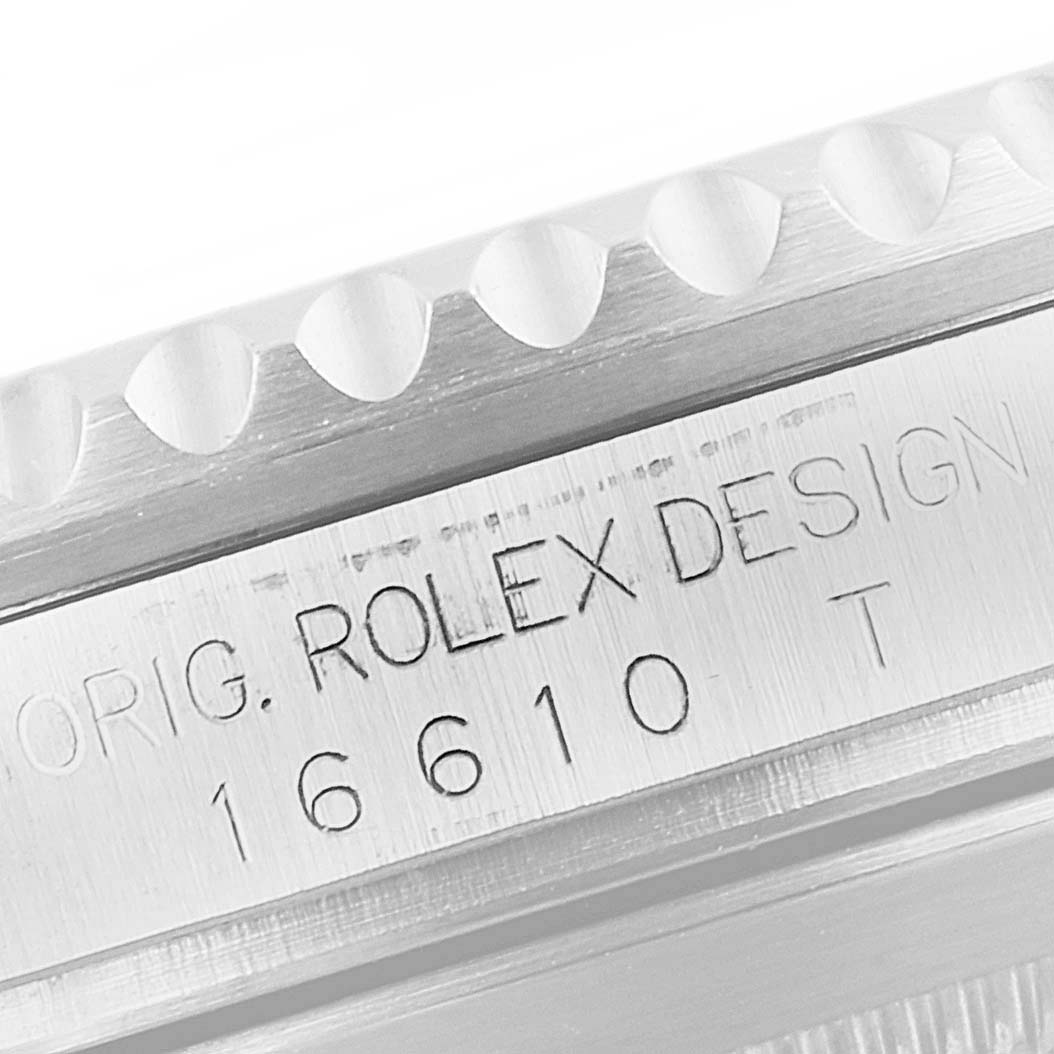 This close-up image shows the engraved model number and bezel edge of a Rolex Submariner 16610 Men
s Stainless Steel Black Dial 16610 Men
s Stainless Steel Black Dial.
