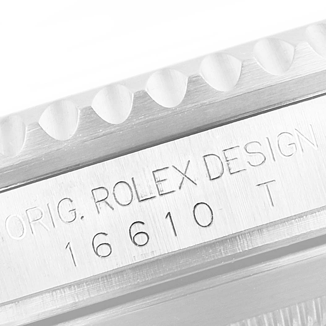 The image shows a close-up of the Rolex Submariner 16610 Men
s Stainless Steel Black Dial 16610 Men
s Stainless Steel Black Dial
s side, revealing the bezel edge and engraved model number "16610 T."