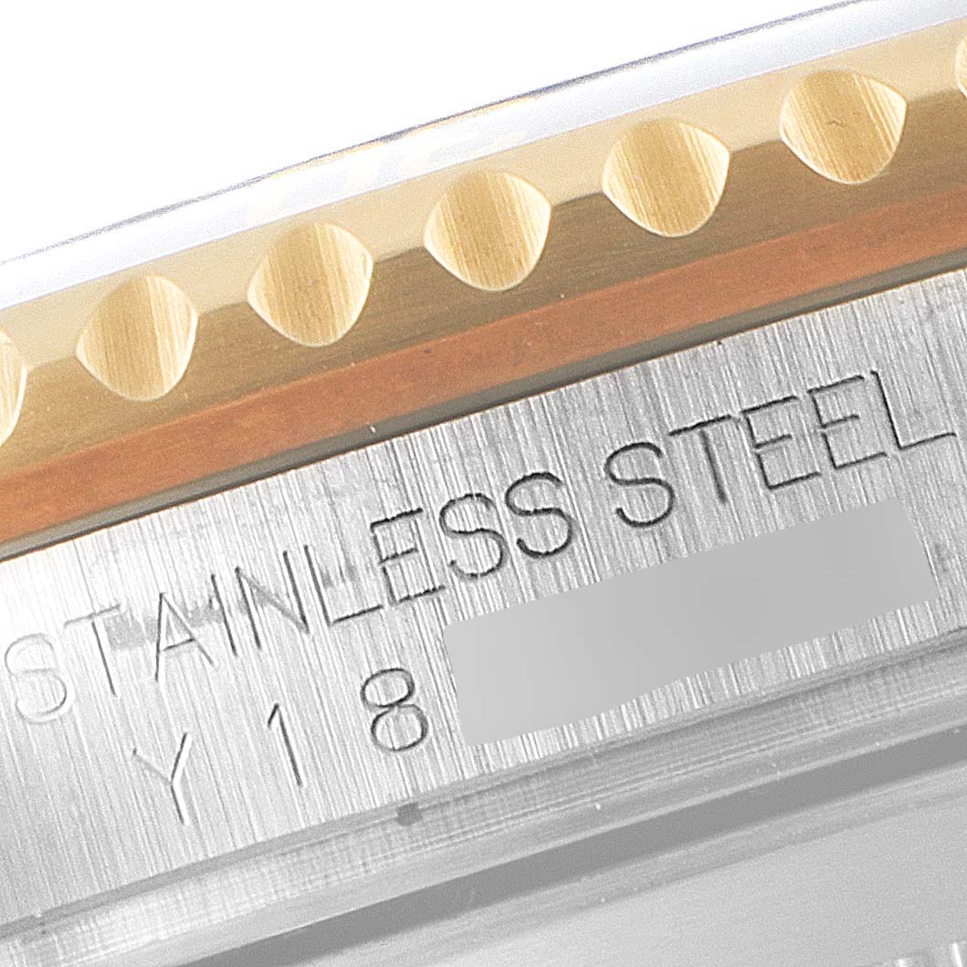 This close-up image shows the side of a Rolex Submariner 16613 Men
s Steel and Gold (two tone) Blue Dial 16613 Men
s Steel and Gold (two tone) Blue Dial watch, highlighting the stainless steel case and engraved details.