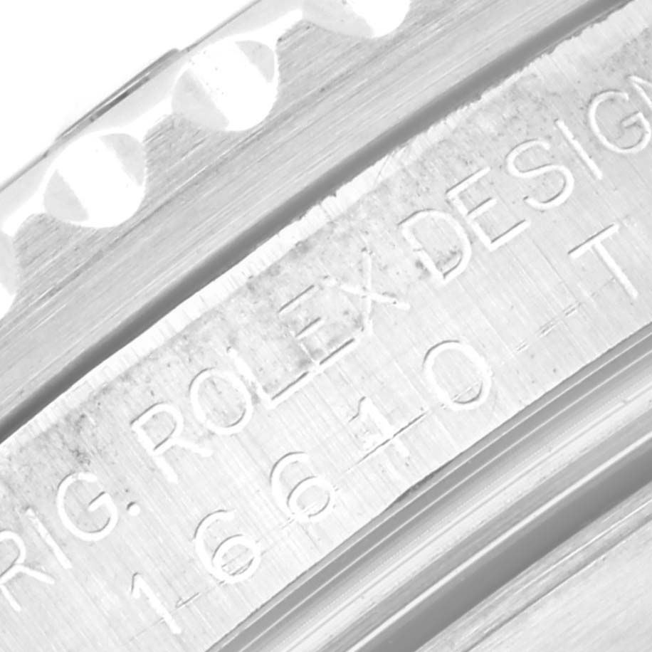 This close-up image of a Rolex Submariner 16610 Men
s Stainless Steel Black Dial 16610 Men
s Stainless Steel Black Dial shows the side engraving with the model number 16610 and part of the bezel teeth.
