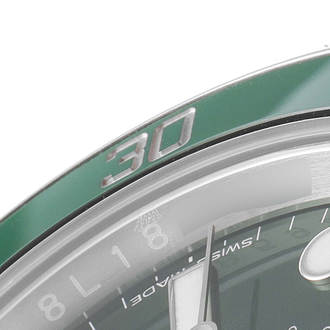 Close-up of the Rolex Submariner 116610LV Men
s Stainless Steel Green Dial 116610LV Men
s Stainless Steel Green Dial watch showing part of the green bezel and a portion of the dial and hand.