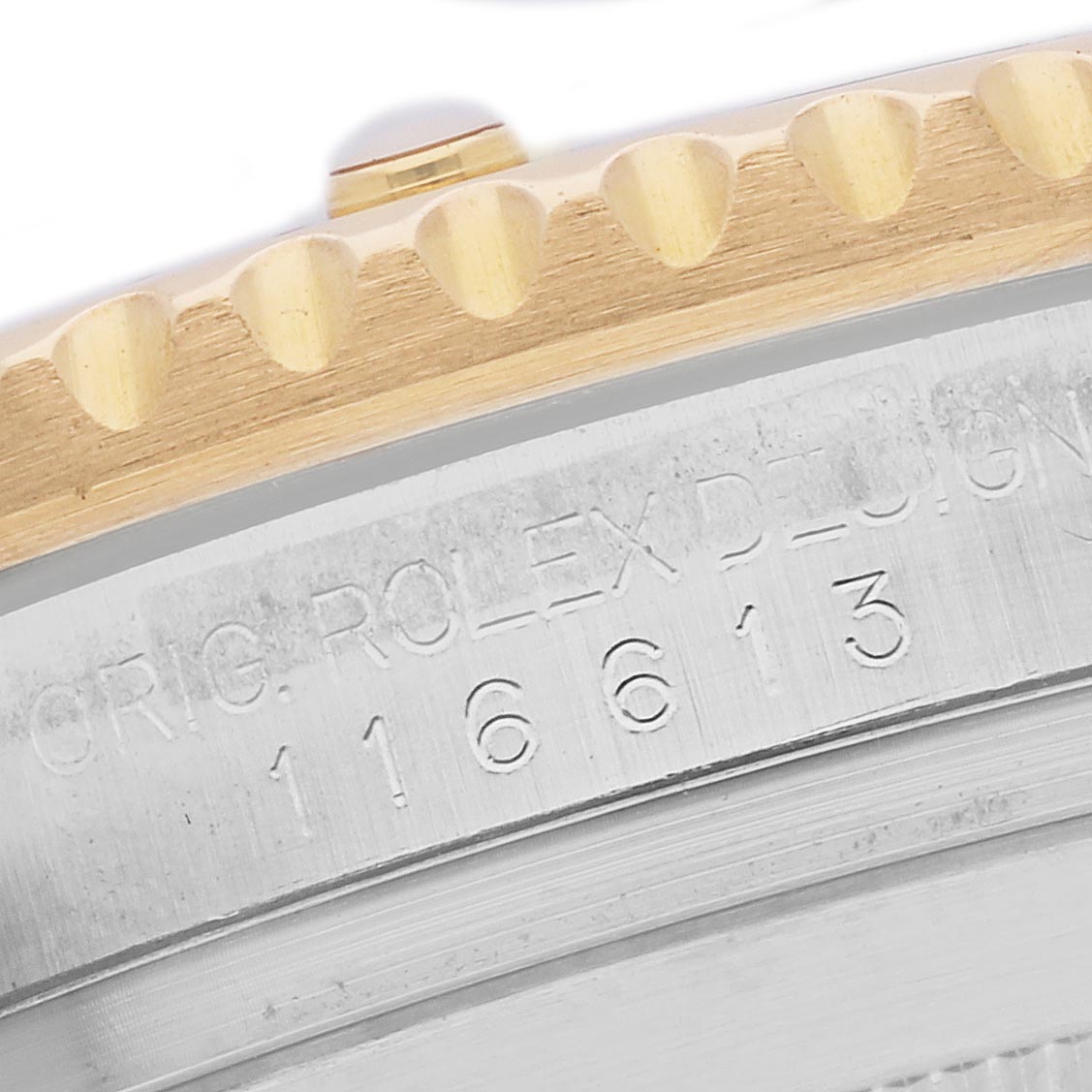 The image shows a close-up of the Rolex Submariner 116613 Men's Steel and Gold (two tone) Black Dial 116613 Men's Steel and Gold (two tone) Black Dial's bezel and engraved case side, highlighting the model number.
