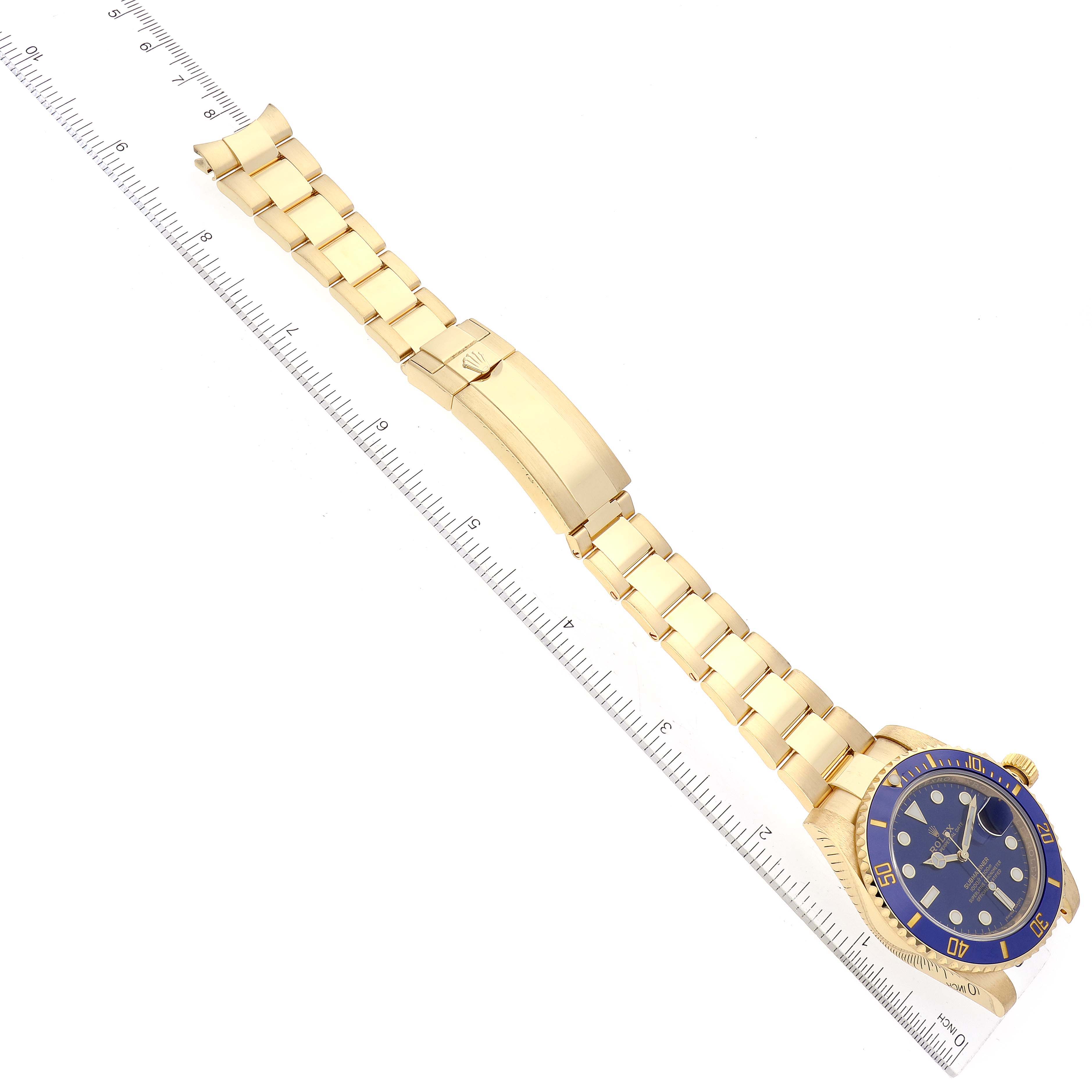 The image shows a top-view angle of a Rolex Submariner 116618 Men's Yellow Gold Blue Dial 116618 Men's Yellow Gold Blue Dial model, focusing on its gold bracelet and blue dial.