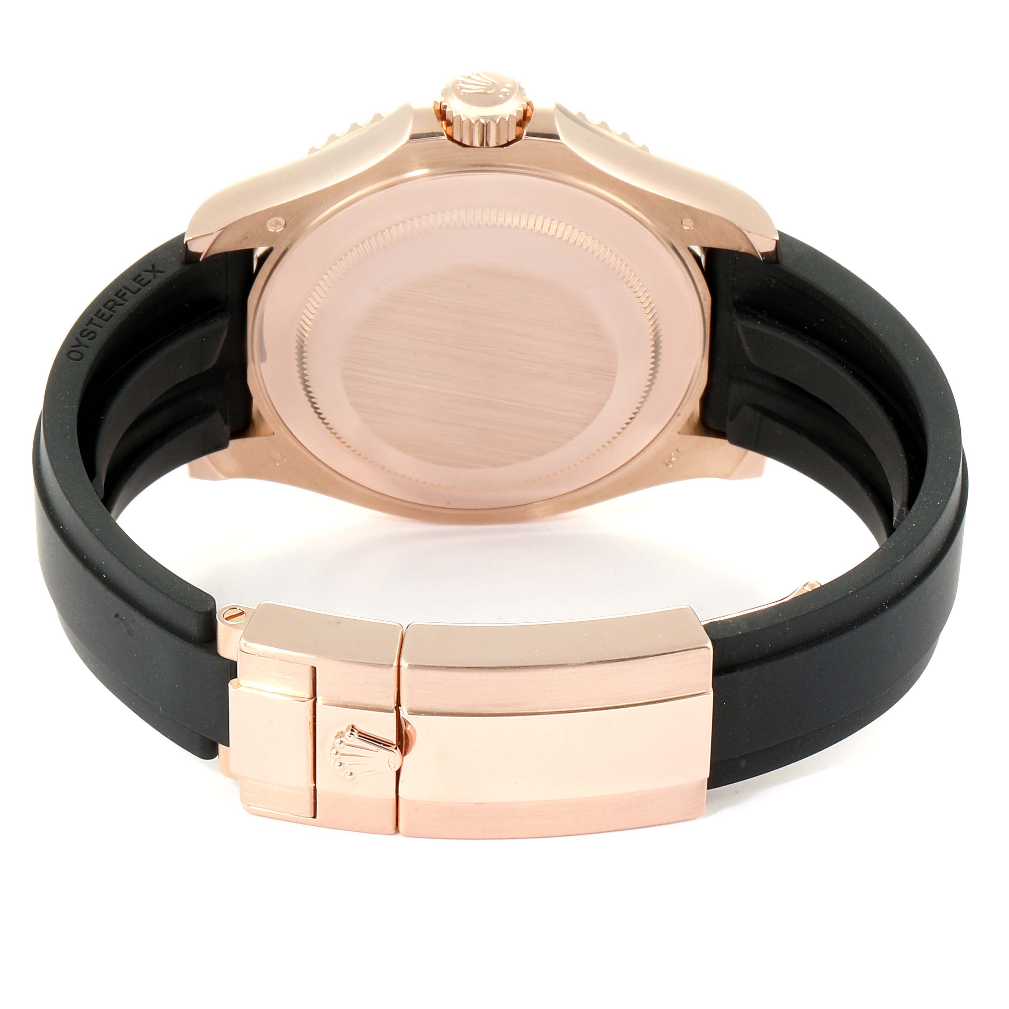 The image shows the back case, crown, and clasp of a Rolex Yacht-Master 116655  Men's Rose Gold Black Dial 116655  Men's Rose Gold Black Dial with a black strap and rose gold details.