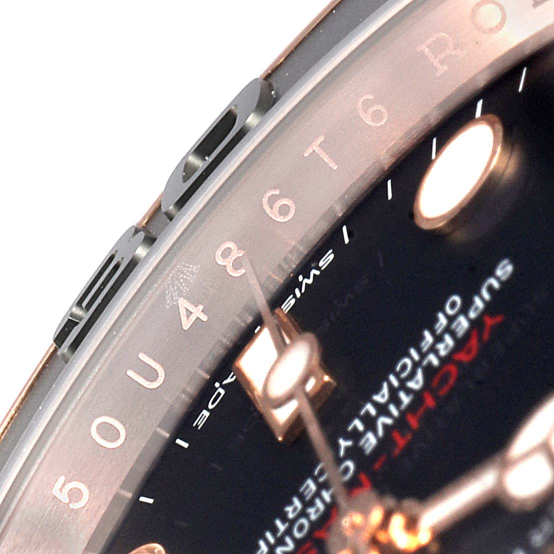 The close-up angle of this Rolex Yacht-Master 116655  Men's Rose Gold Black Dial 116655  Men's Rose Gold Black Dial watch shows parts of the bezel, dial, and hands.