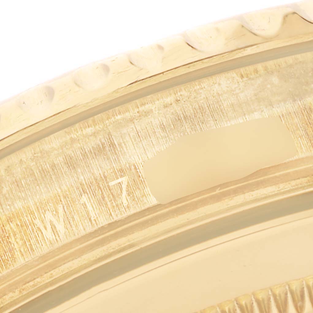 The image shows a close-up of the bezel and serial number area of a Rolex Yacht-Master 16628 Men's Yellow Gold White Dial 16628 Men's Yellow Gold White Dial watch.