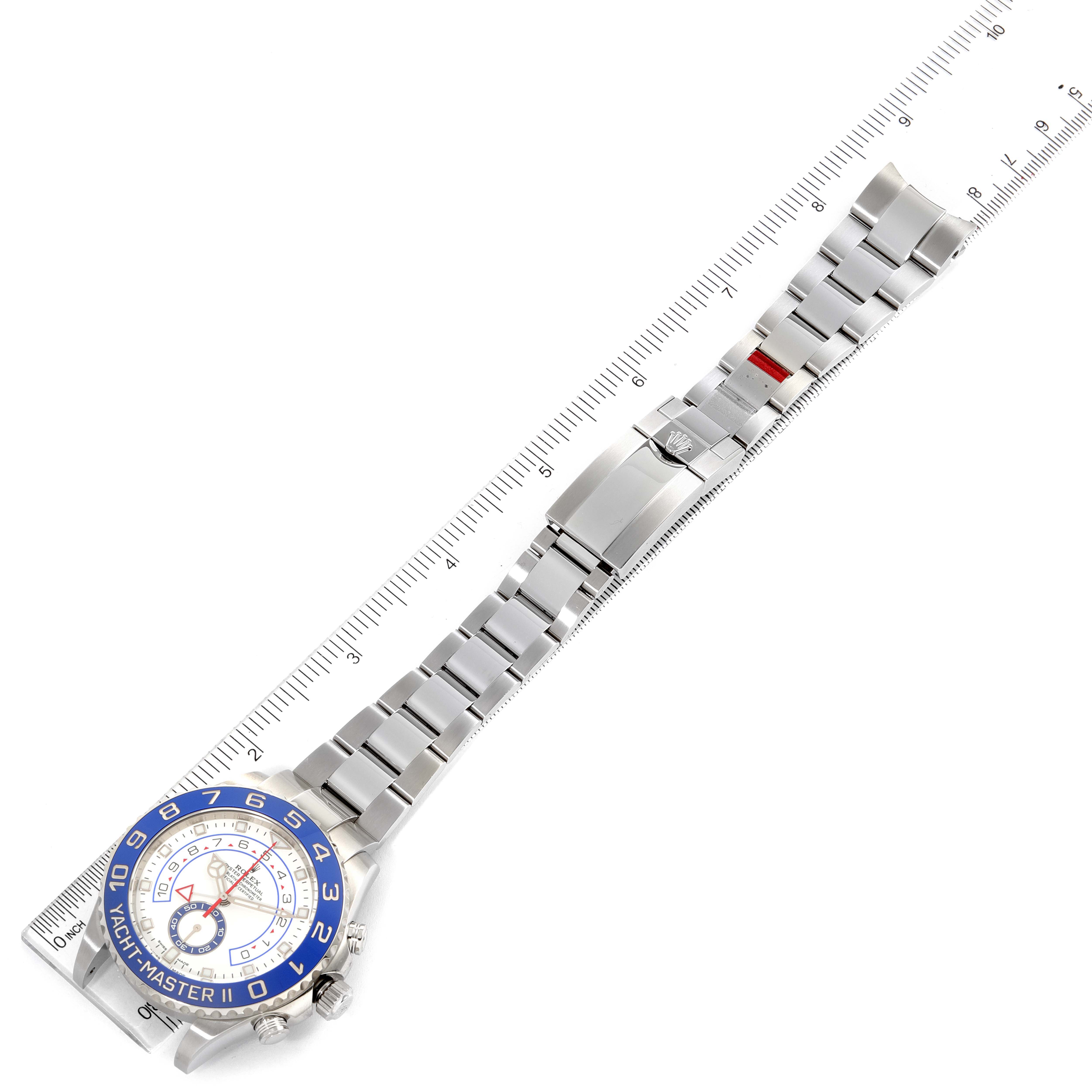 This image shows the Rolex Yacht-Master 116680 Men
s Stainless Steel White Dial 116680 Men
s Stainless Steel White Dial watch laid flat with its face, bracelet, and clasp fully displayed against a ruler.