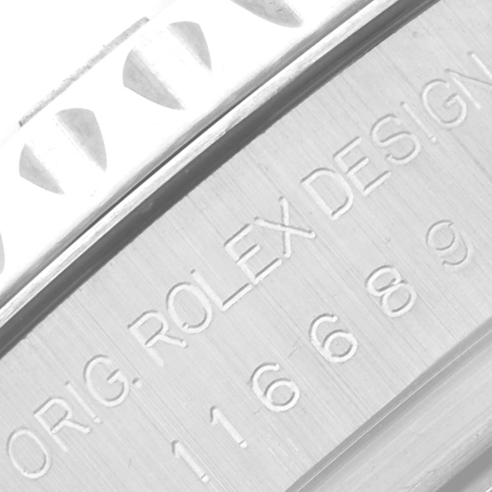 The image shows a close-up of the side of the case and outer edge of the bezel of a Rolex Yacht-Master 116689 Men's White Gold White Dial 116689 Men's White Gold White Dial, displaying the engraving.