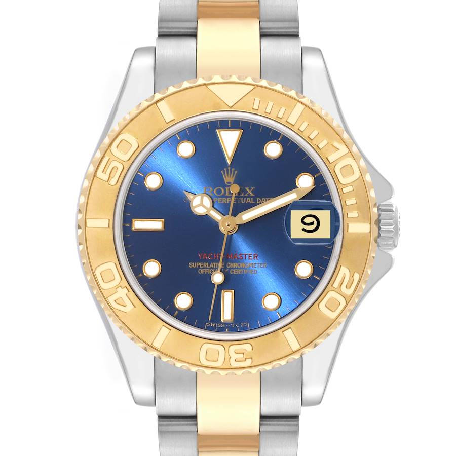 The image shows a front-angle view of a Rolex Yacht-Master watch, highlighting its blue dial, gold bezel, and two-tone bracelet.