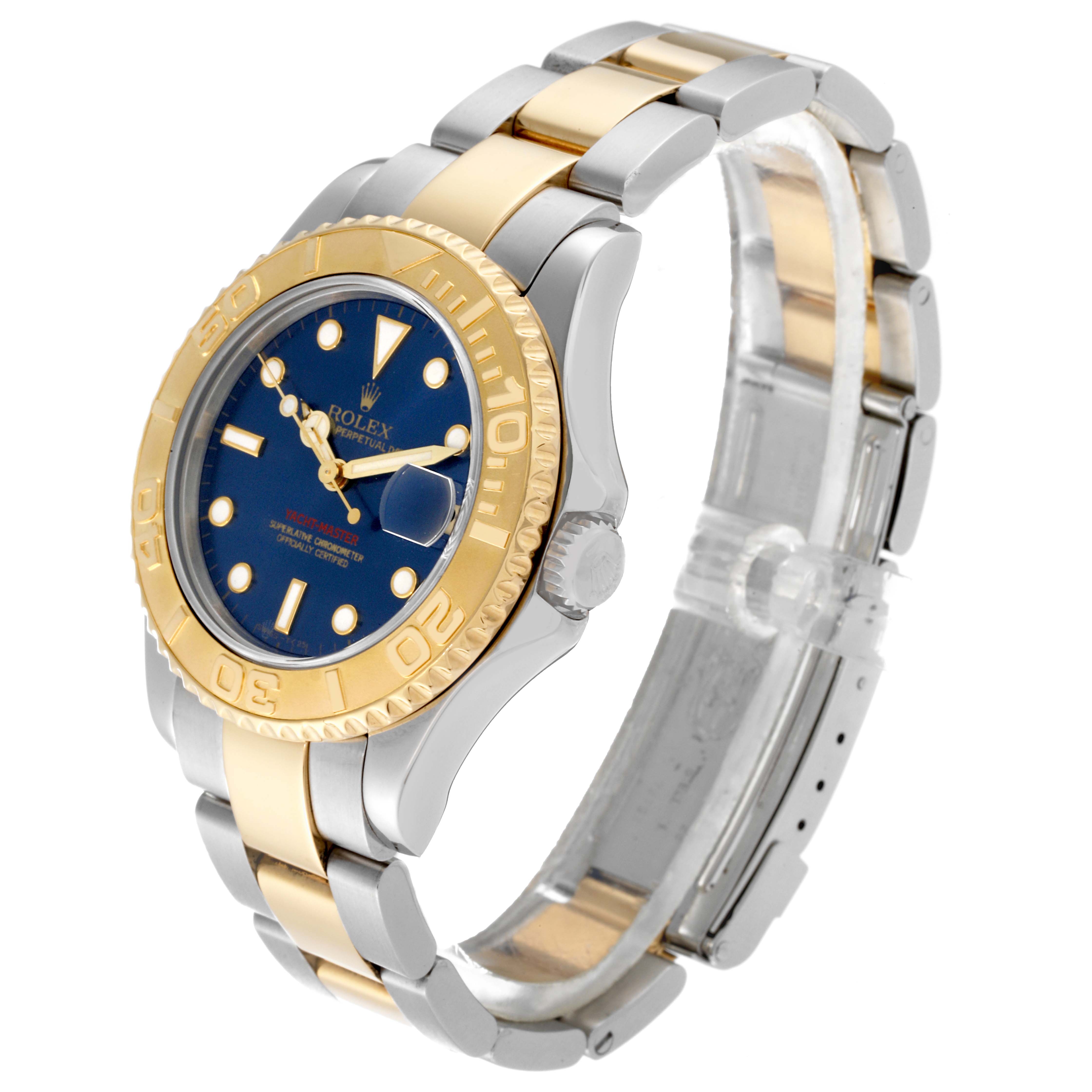 This image shows a side and top angle of a Rolex Yacht-Master 68623 Men
s Steel and Gold (two tone) Blue Dial 68623 Men
s Steel and Gold (two tone) Blue Dial watch, highlighting its blue dial, gold bezel, and two-tone bracelet.