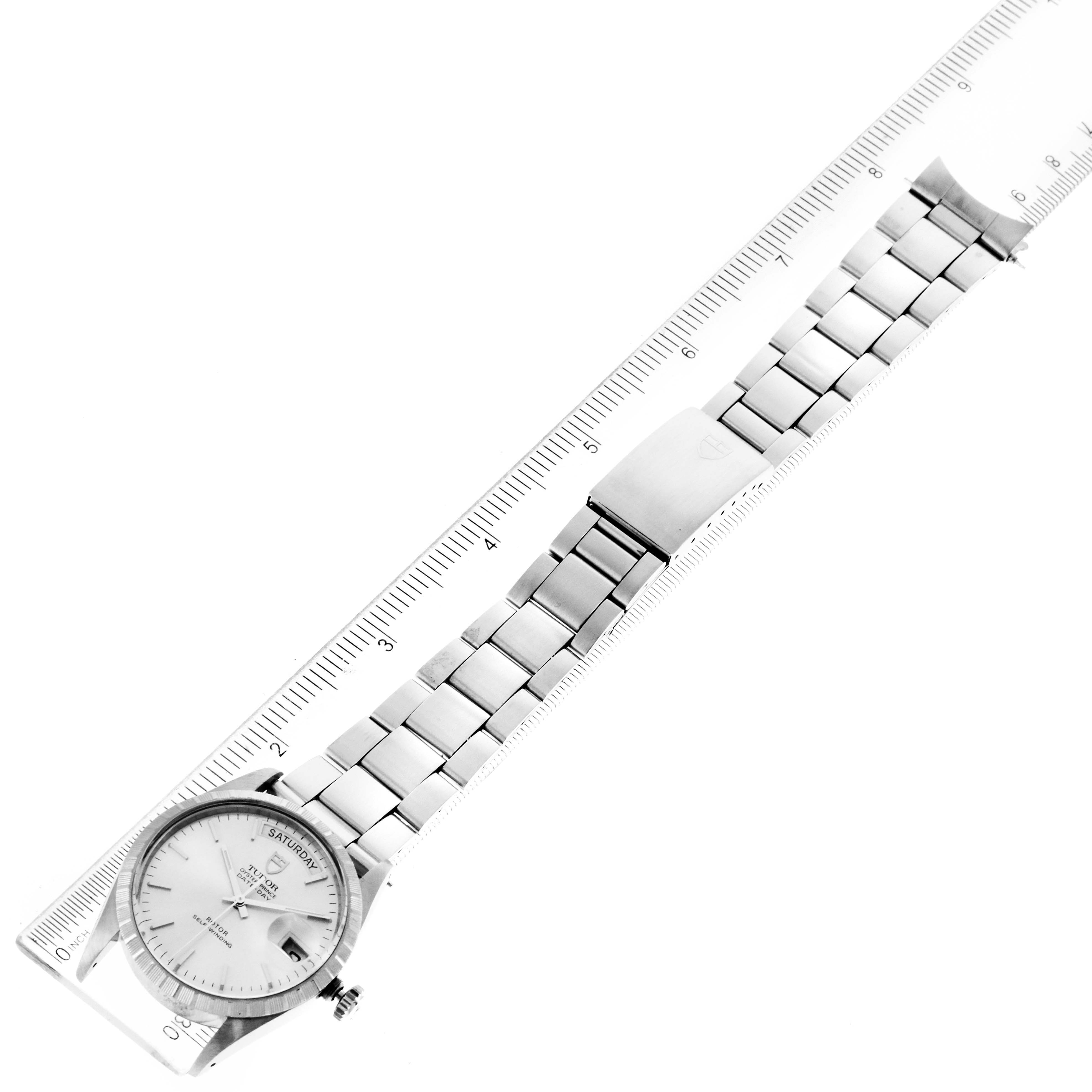 The Tudor Prince 94510 Men's Stainless Steel Silver Dial 94510 Men's Stainless Steel Silver Dial model watch is shown from a top-down angle, displaying the watch face, band, and clasp alongside a ruler for scale.