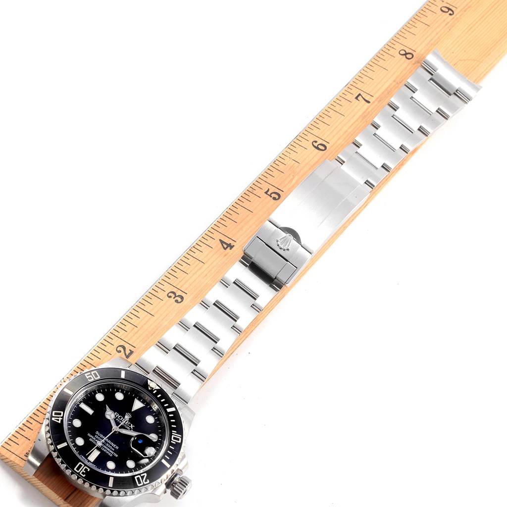 The image shows the Rolex 116610 Men's Stainless Steel Black Dial 116610 Men's Stainless Steel Black Dial Submariner Cerachrom Bezel Black Dial Steel Men's Watch 116610 laid flat next to a ruler.