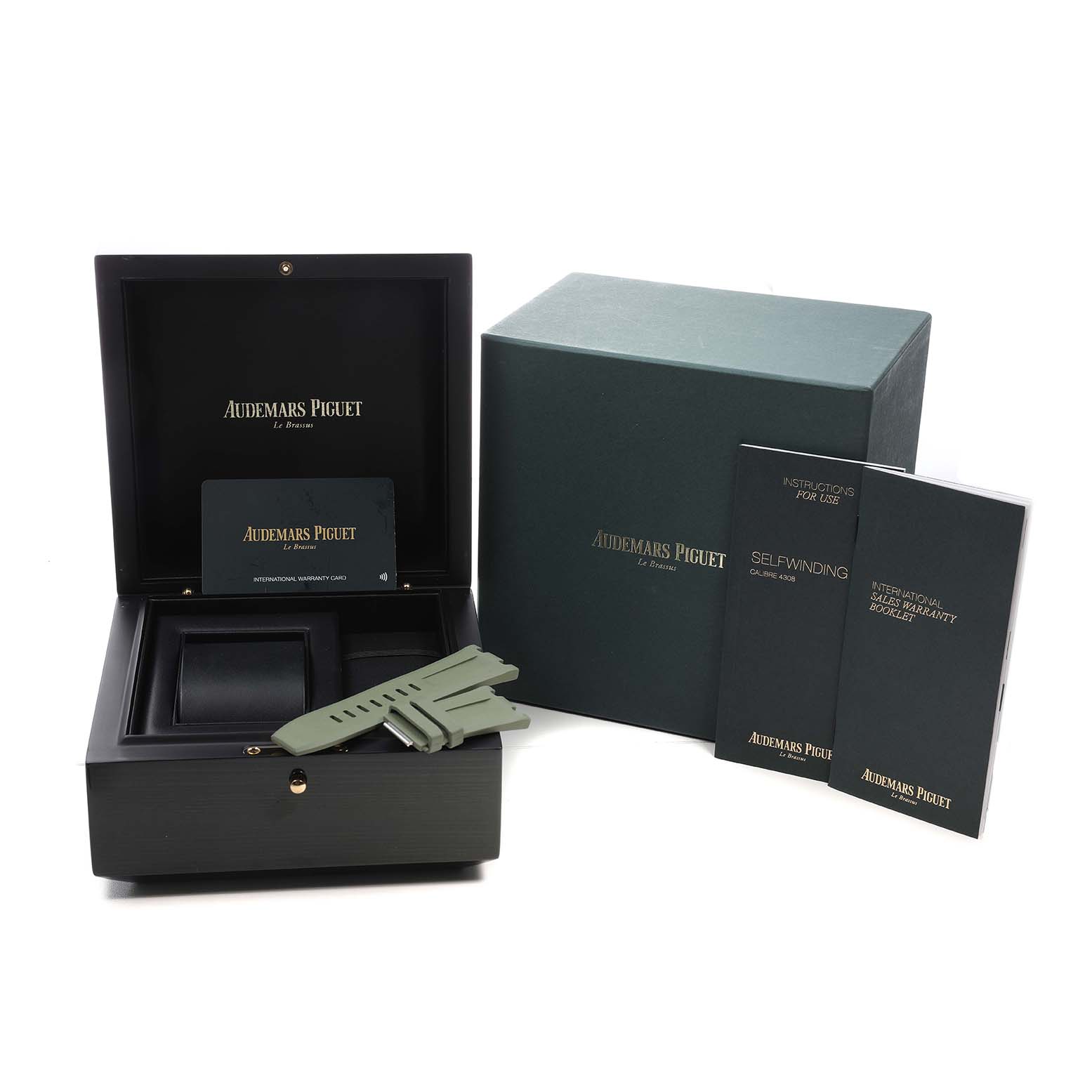 The image shows an open Audemars Piguet Royal Oak Offshore 15720ST Men's Stainless Steel Green Dial box, warranty card, extra strap, and manuals at a slight angle.
