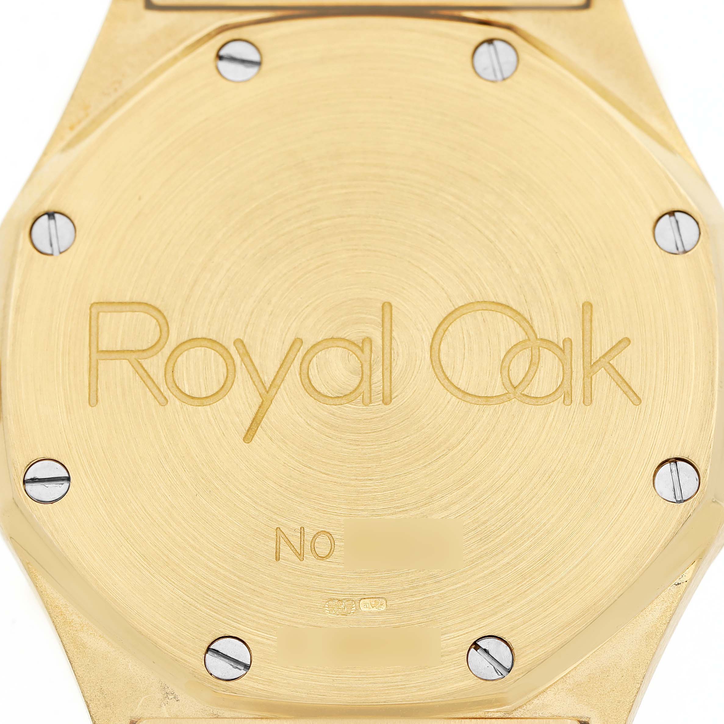 The image shows the case back of the Audemars Piguet Royal Oak 14800BA Men's Stainless Steel White Dial watch, highlighting its brushed gold surface and screws.
