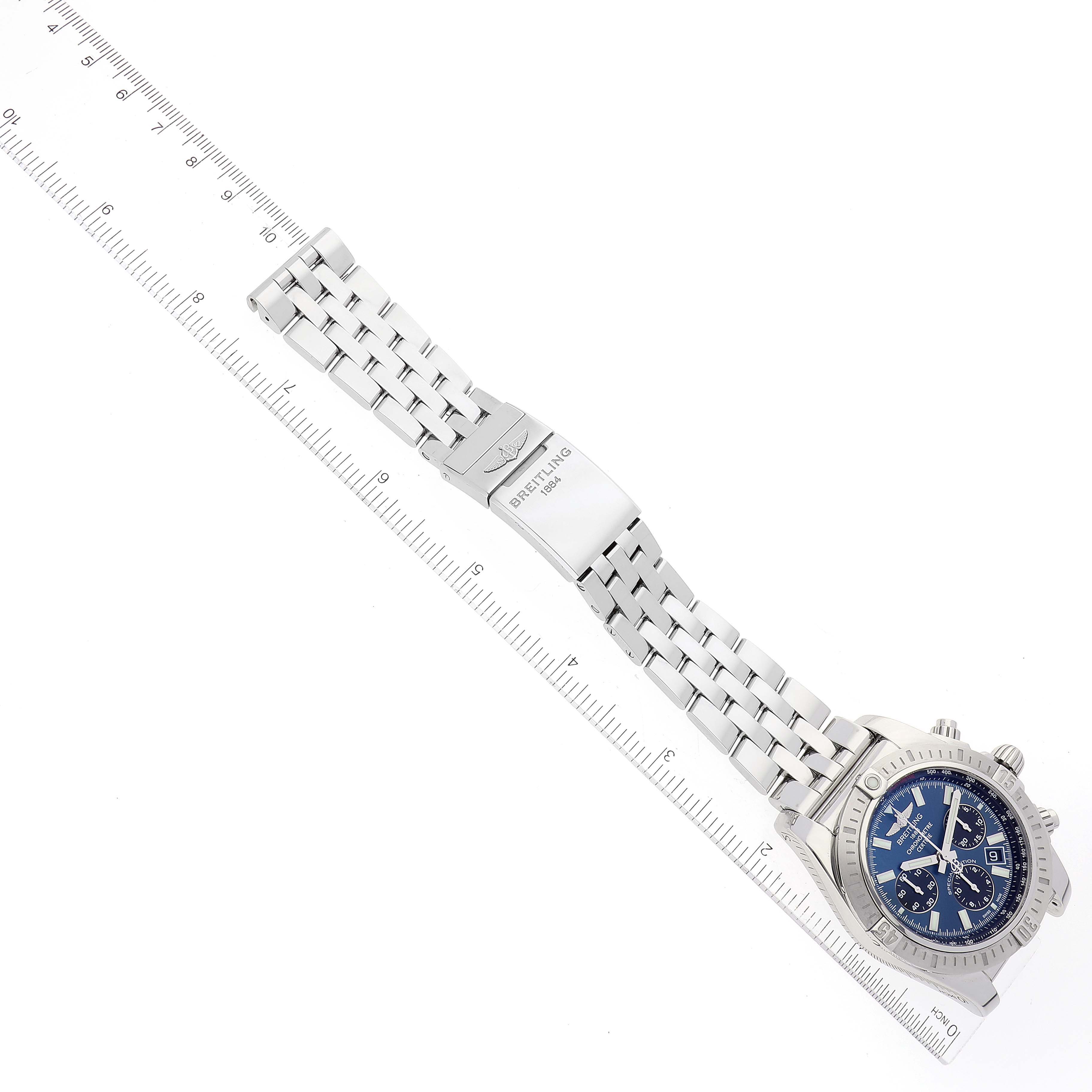The image shows a top-down angle of a Breitling Chronomat AB0115 Men
s Stainless Steel Blue Dial AB0115 Men
s Stainless Steel Blue Dial watch, highlighting its bracelet, clasp, case, and bezel.