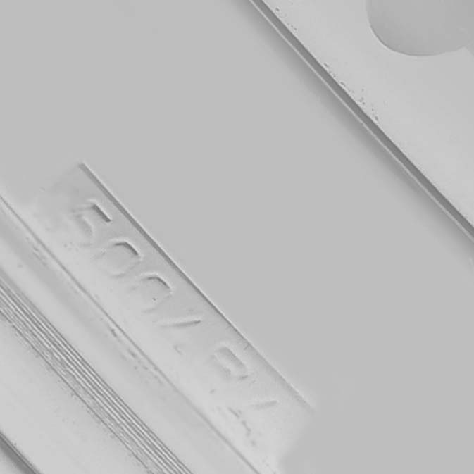 The image shows a close-up of the side detailing on a Breitling Navitimer A23322 Men's Stainless Steel Black Dial, focusing on engraved text.