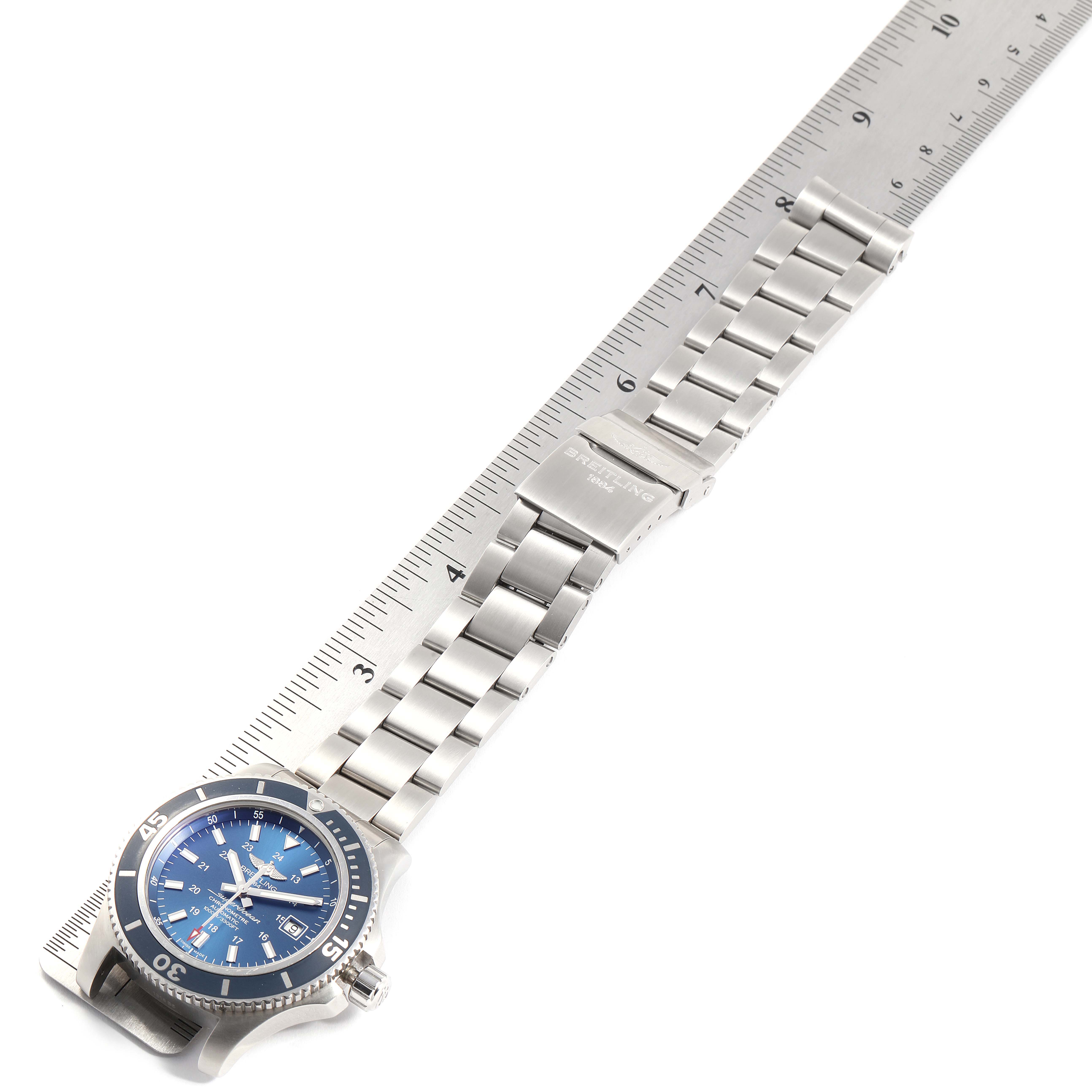 The image shows a Breitling Superocean A17392 Men
s Stainless Steel Blue Dial A17392 Men
s Stainless Steel Blue Dial watch laid flat, showing the face, bezel, and stainless steel bracelet measured against a ruler.