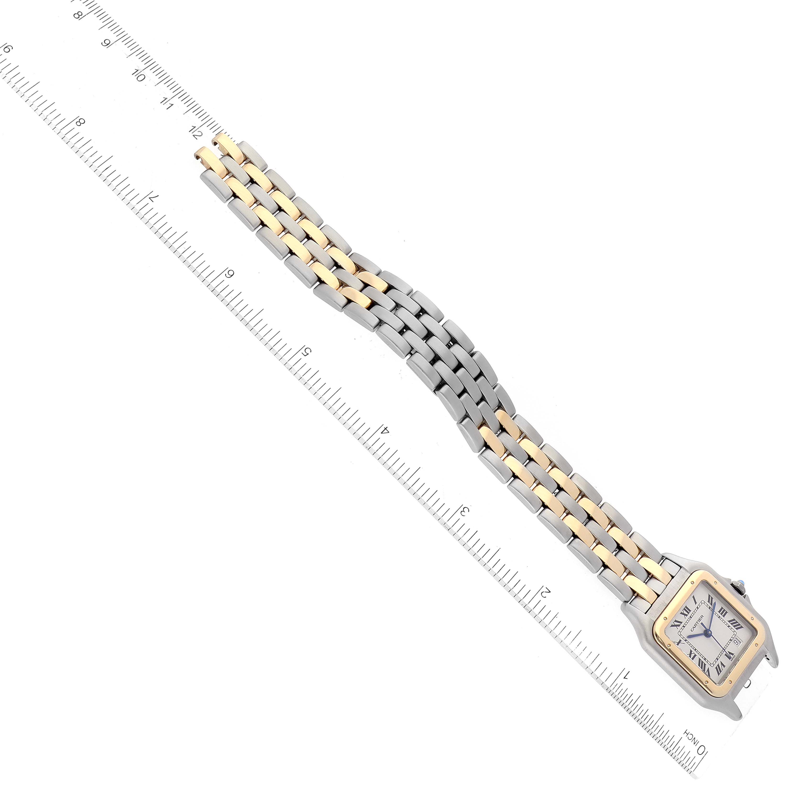 The Cartier Panthere W25028B8 Women's Steel and Gold (two tone) Silver Dial W25028B8 Women's Steel and Gold (two tone) Silver Dial watch is shown lying flat with its face and two-tone metal bracelet displayed next to a ruler.