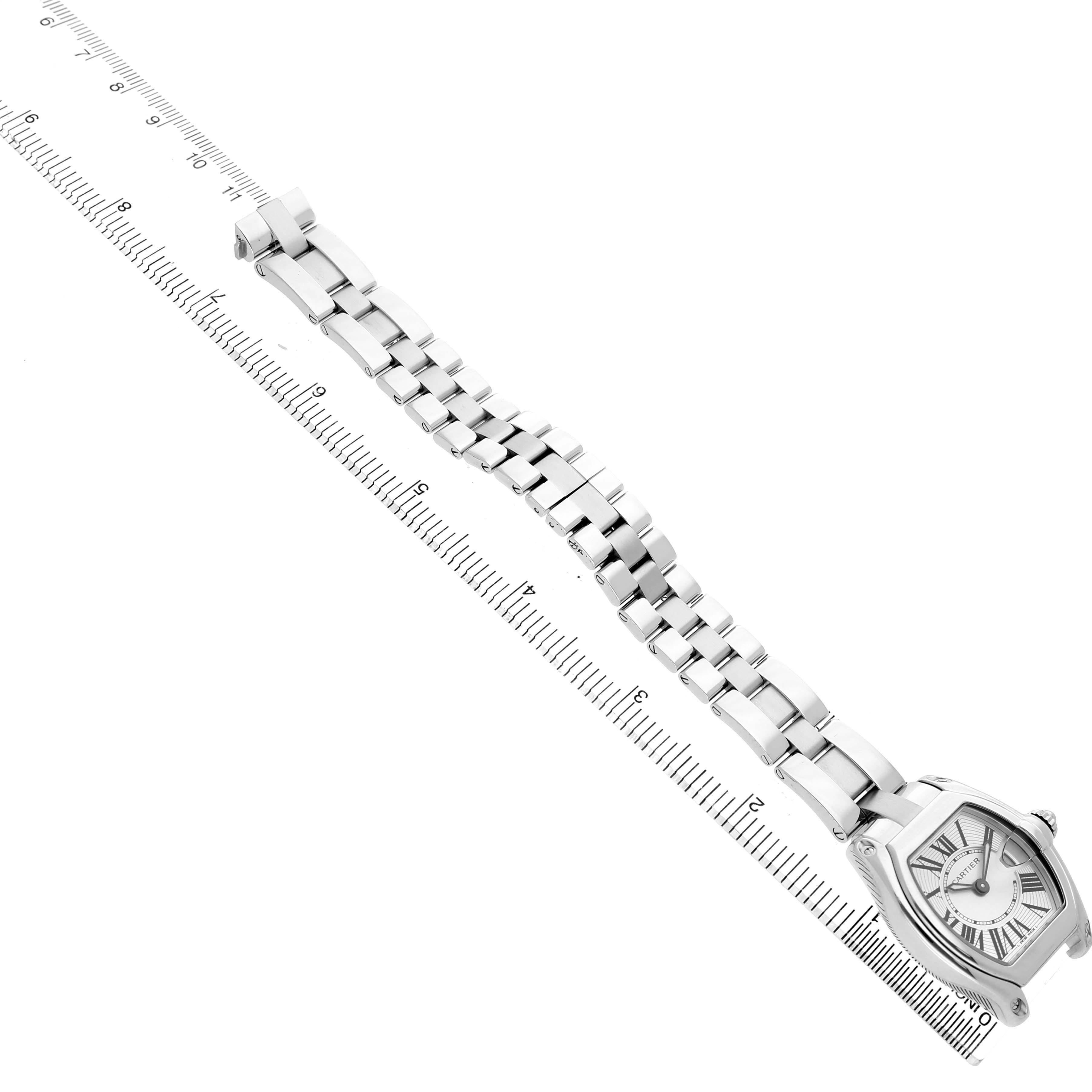 The Cartier Roadster W62016V3 Women's Stainless Steel Silver Dial watch is shown at an angle highlighting its face and full bracelet with a ruler for scale.