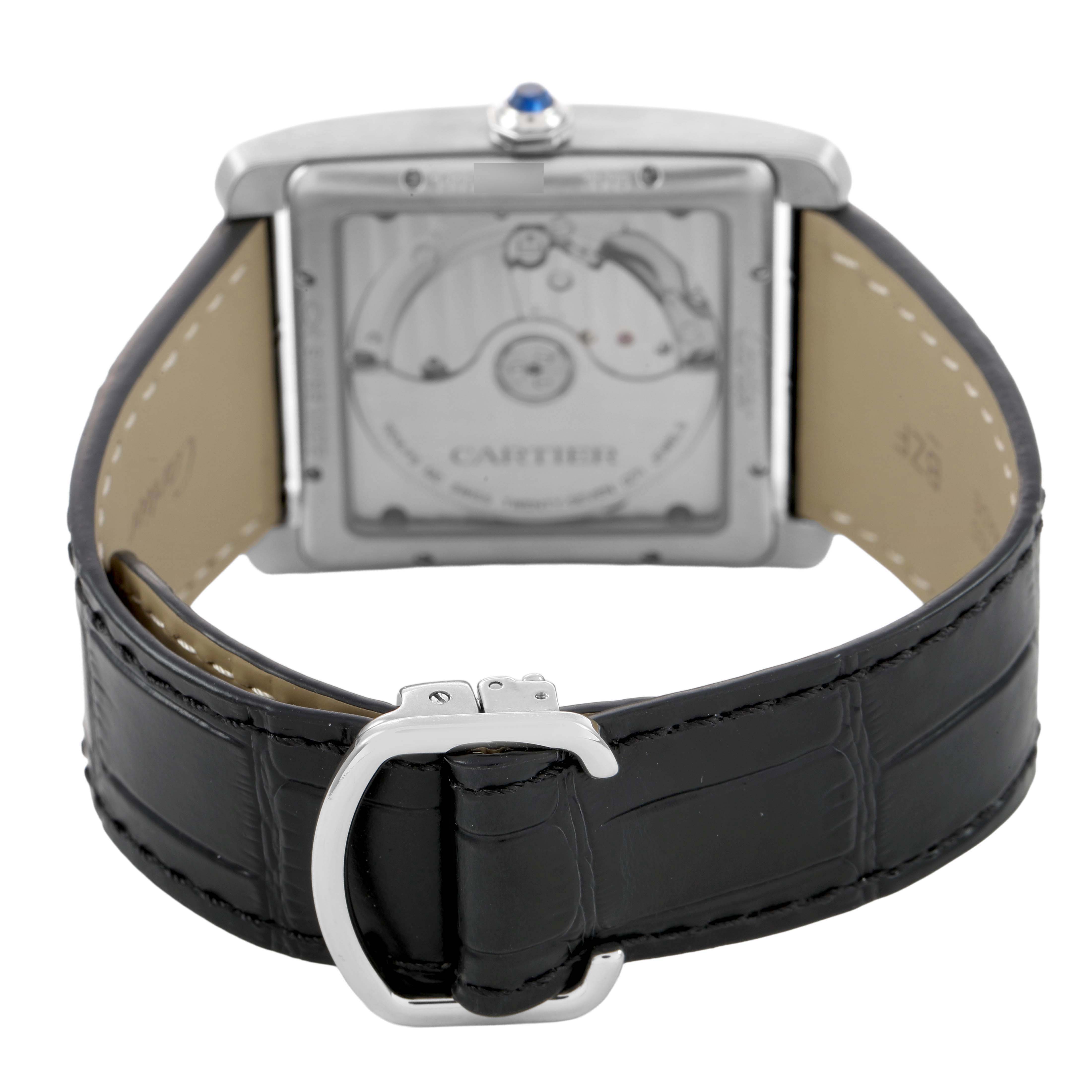 The Cartier Tank MC W5330003 Men's Stainless Steel Silver Dial watch is shown from the back, highlighting its movement and black leather strap with clasp.