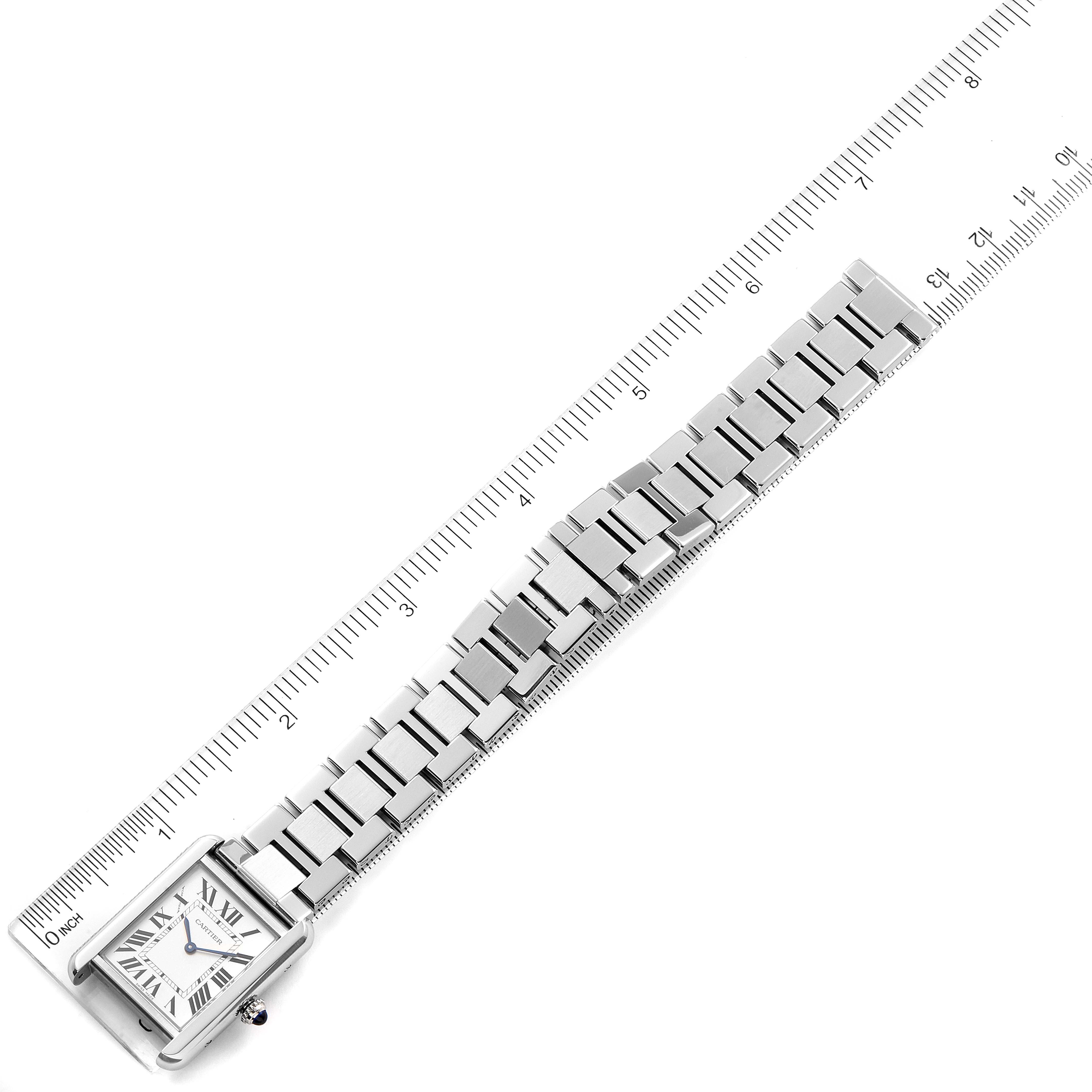 The Cartier Tank Solo W5200013 Women's Stainless Steel Silver Dial W5200013 Women's Stainless Steel Silver Dial watch is shown at a top-down angle with its face and full metal strap visible alongside a ruler for scale.